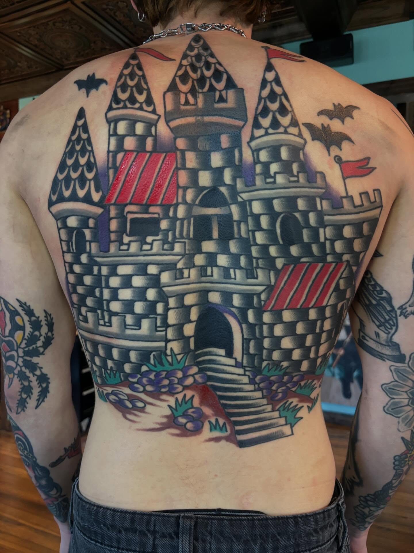 Castle American traditional tattoo on the back by Mitch Ashpaugh