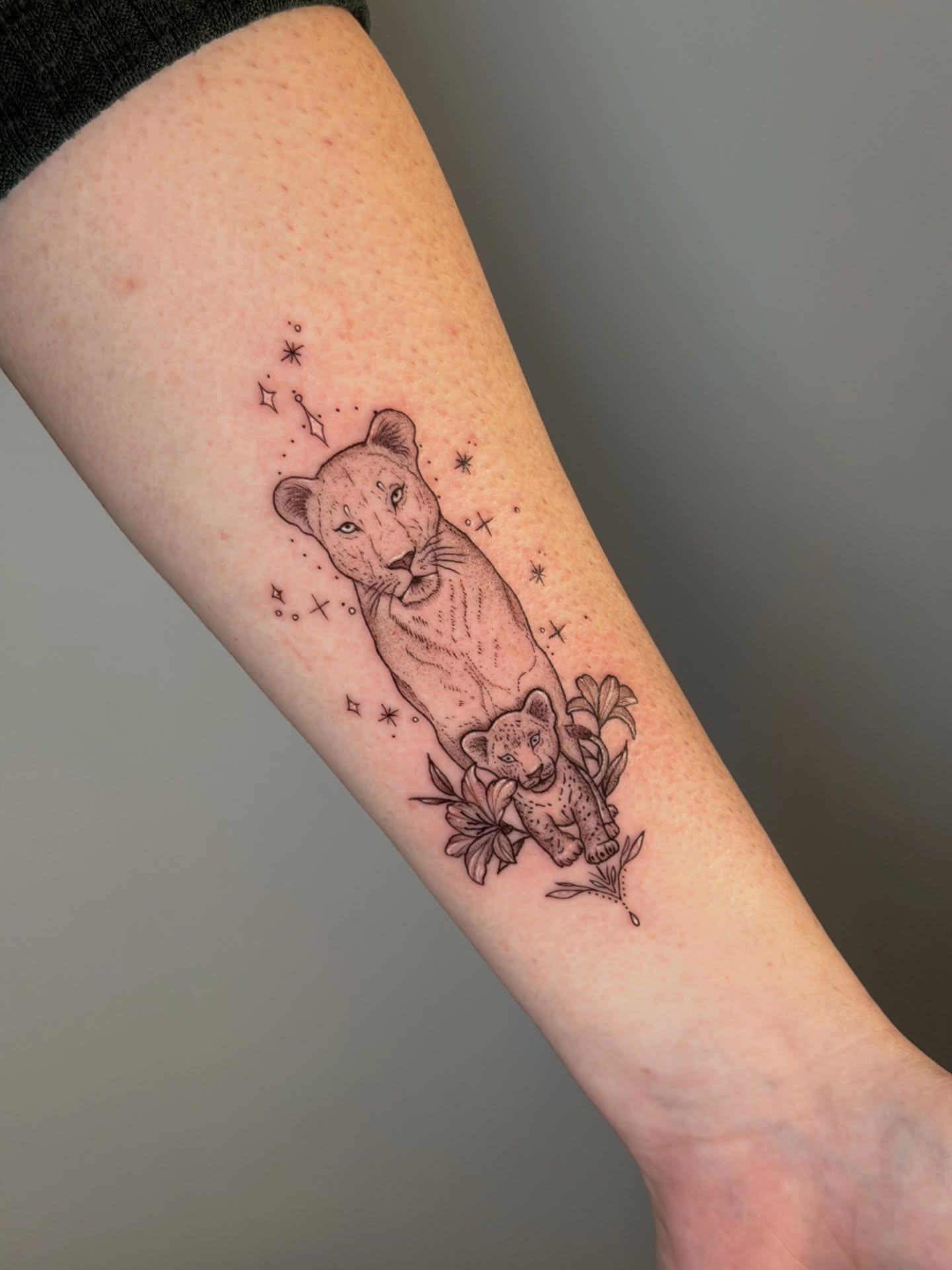 Lioness and cub dotwork tattoo on the forearm by Mandy Kaur