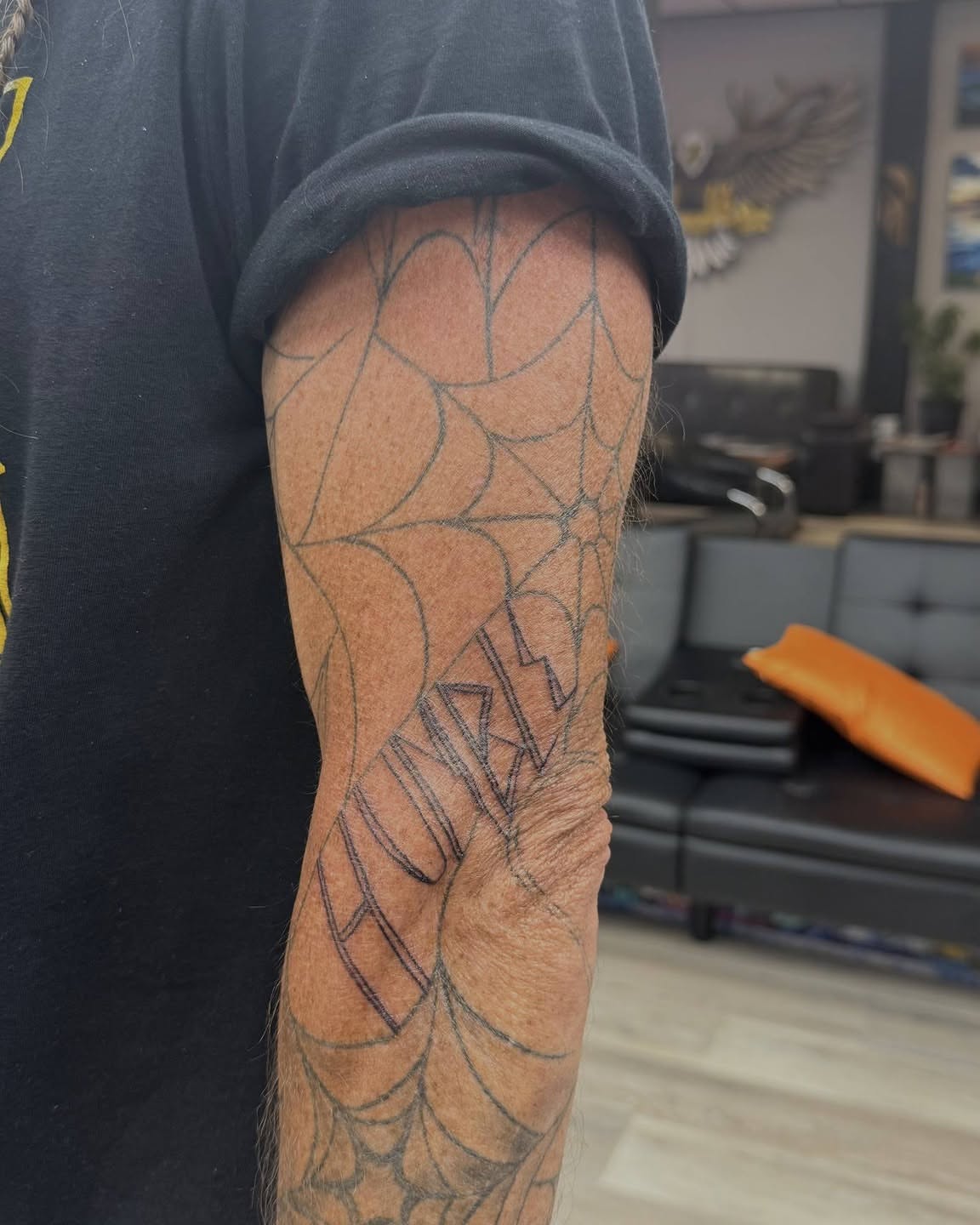 Geometric spiderweb geometric tattoo on the forearm by Danny Stewart