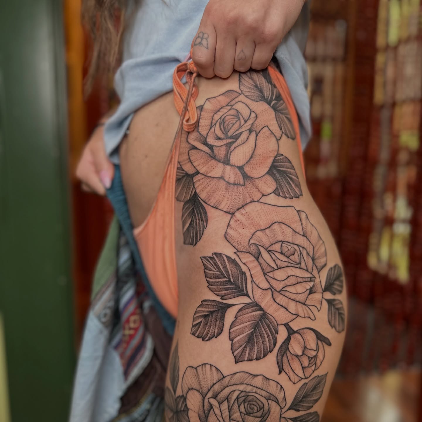 Roses black and grey tattoo on the thigh by Brieana Smith