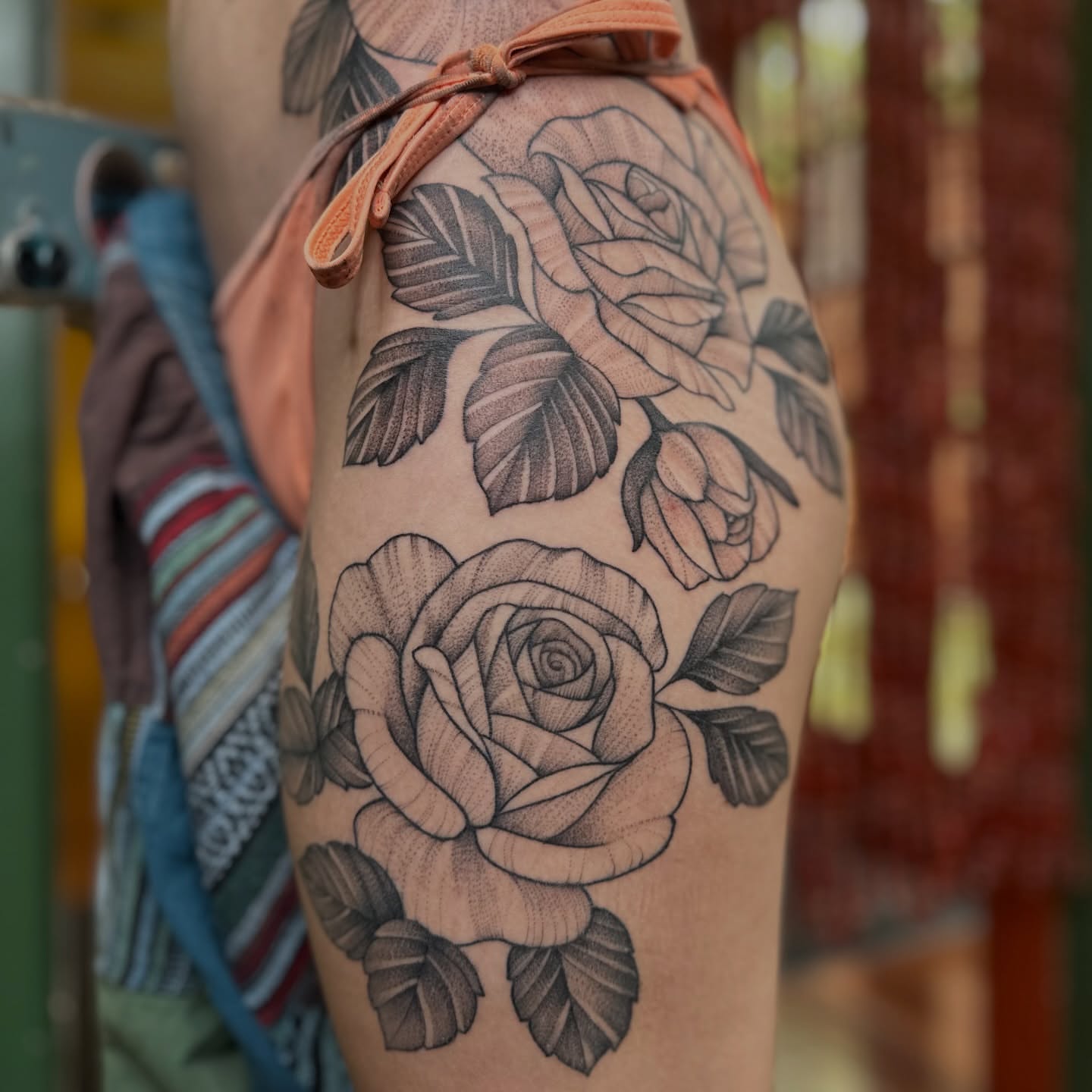 Roses black and grey tattoo on the thigh by Brieana Smith