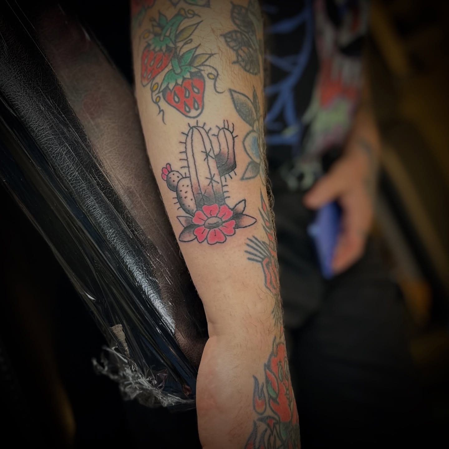 Cactus and flower American traditional tattoo on the forearm by Madeline Seeley