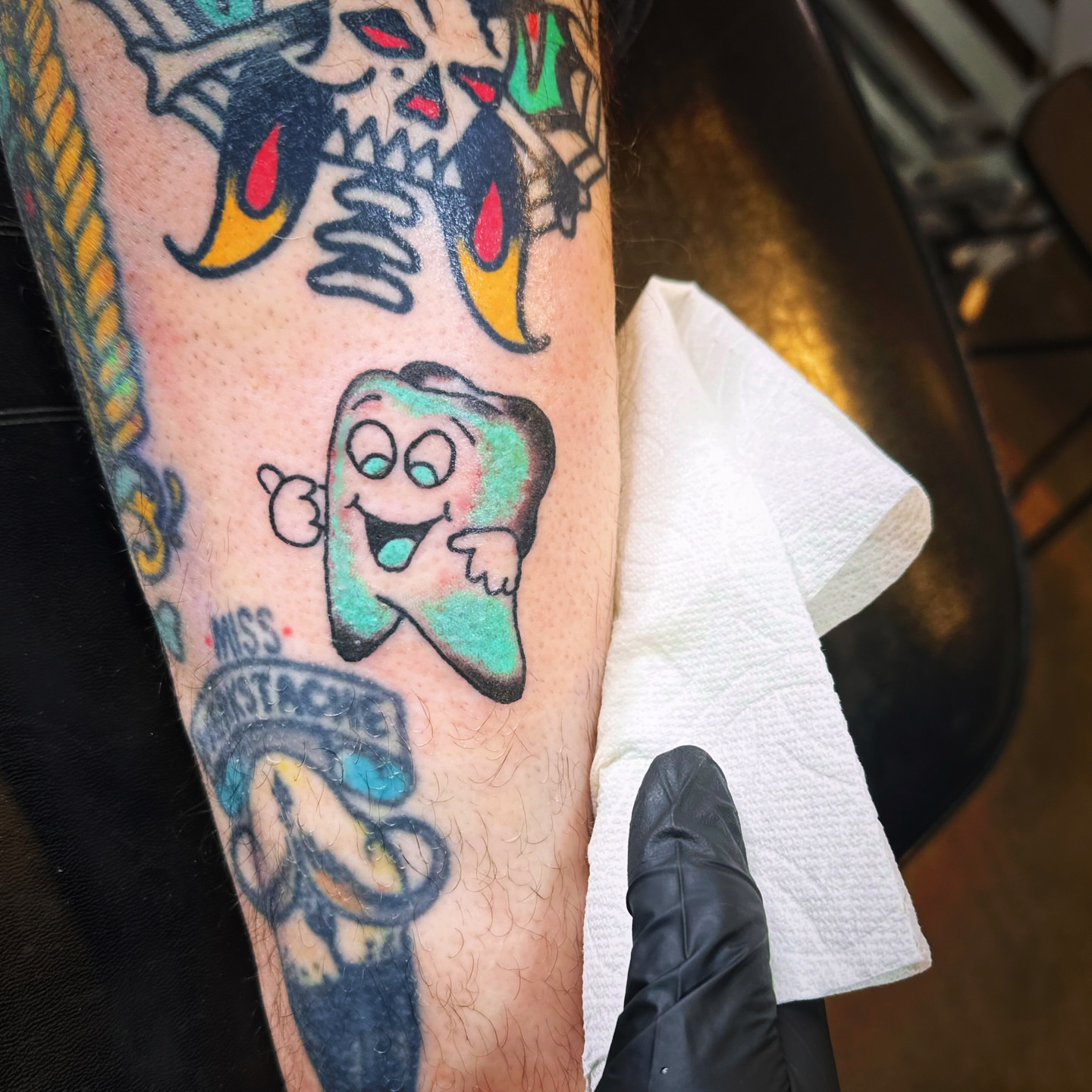 Tooth character American traditional tattoo on the forearm by Madeline Seeley