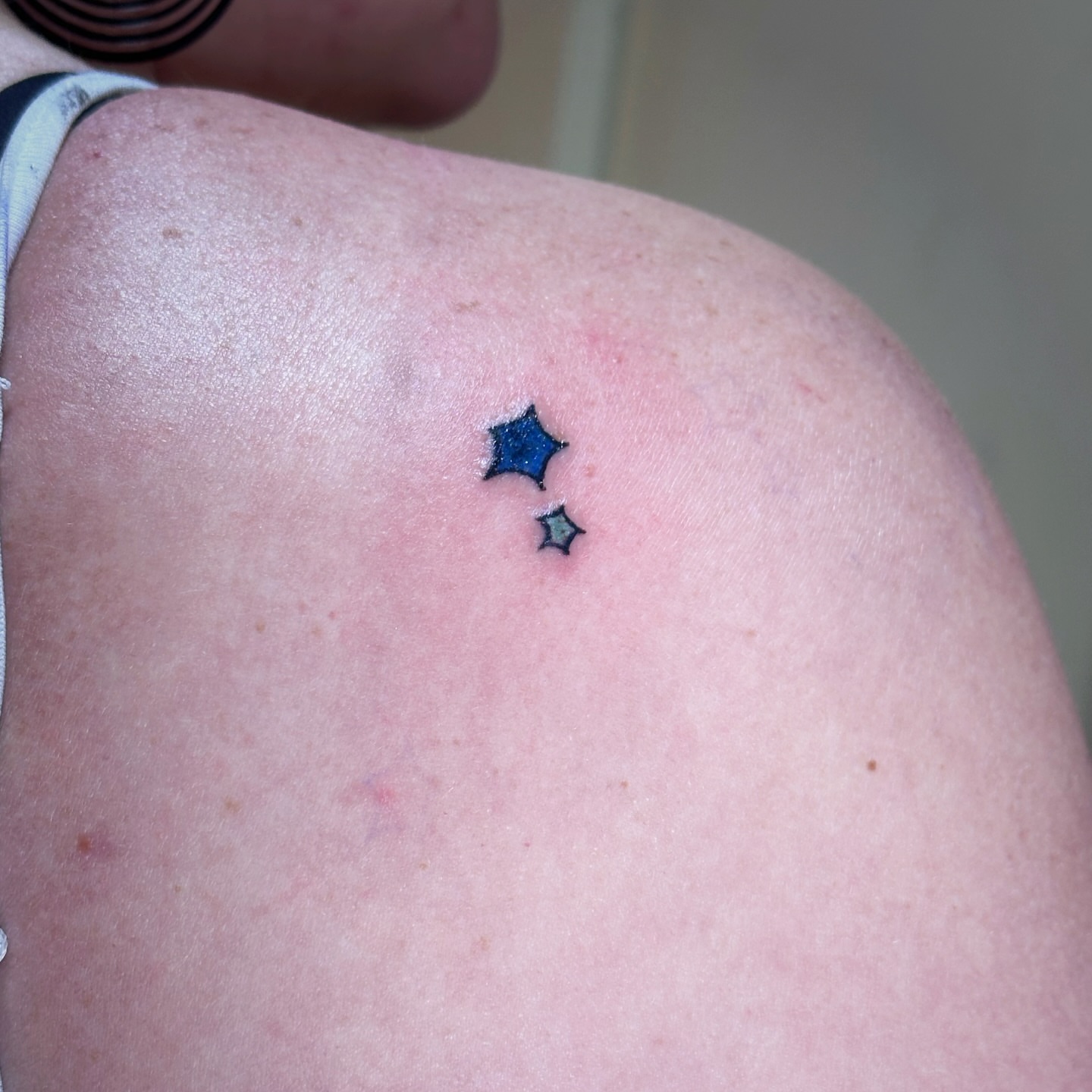 Stars dotwork tattoo on the shoulder by Madeline Seeley