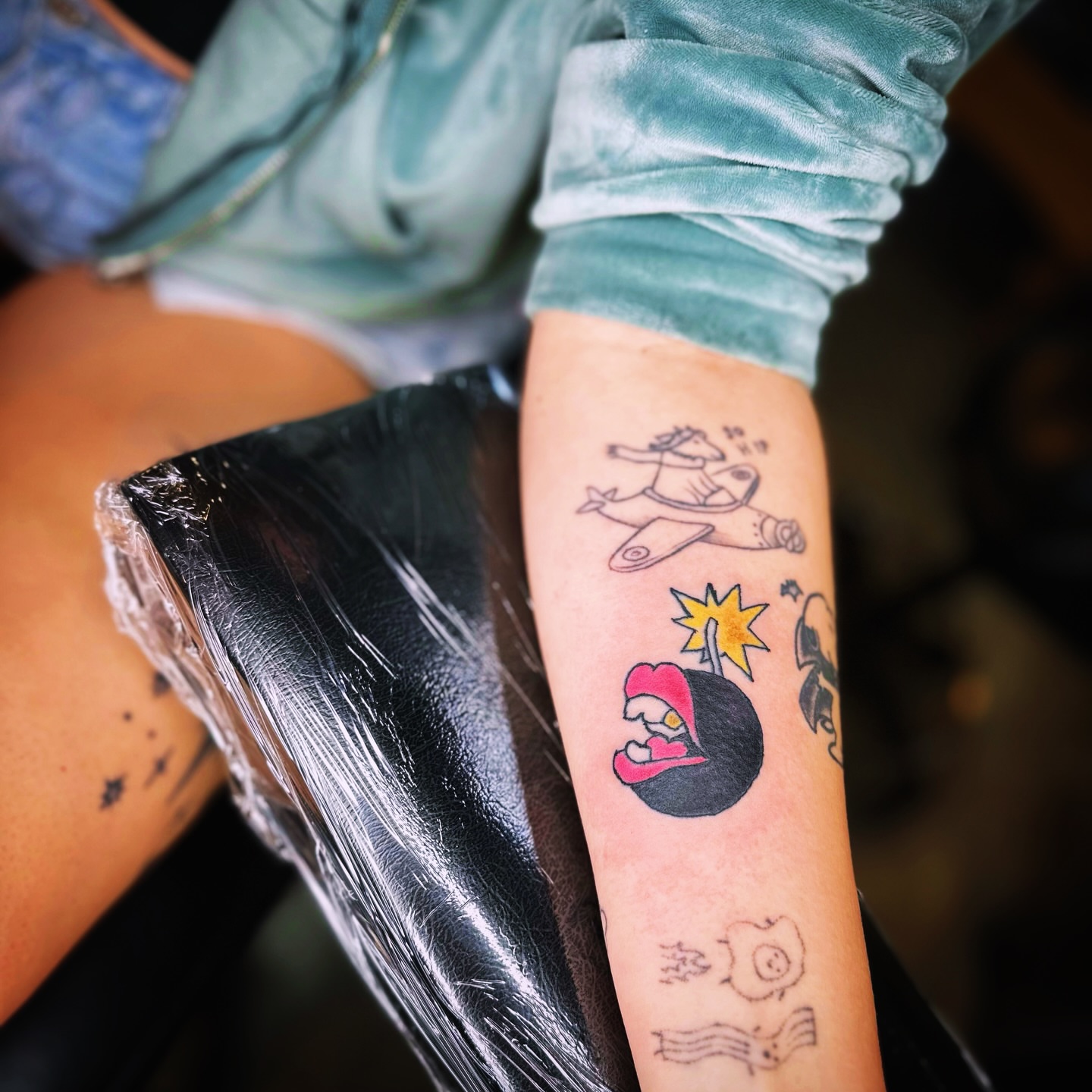 Cartoonish characters dotwork tattoo on the forearm by Madeline Seeley