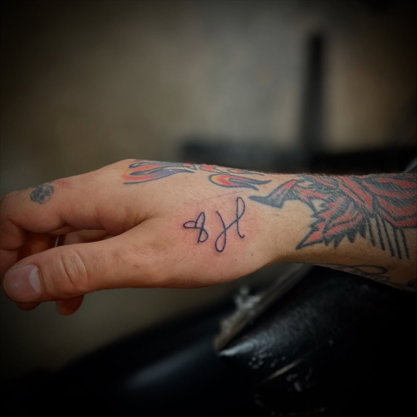 Signature lettering script tattoo on the forearm by Madeline Seeley