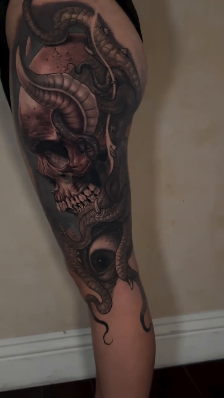 Demonic skull with tentacles realism tattoo on the leg by Isaac
