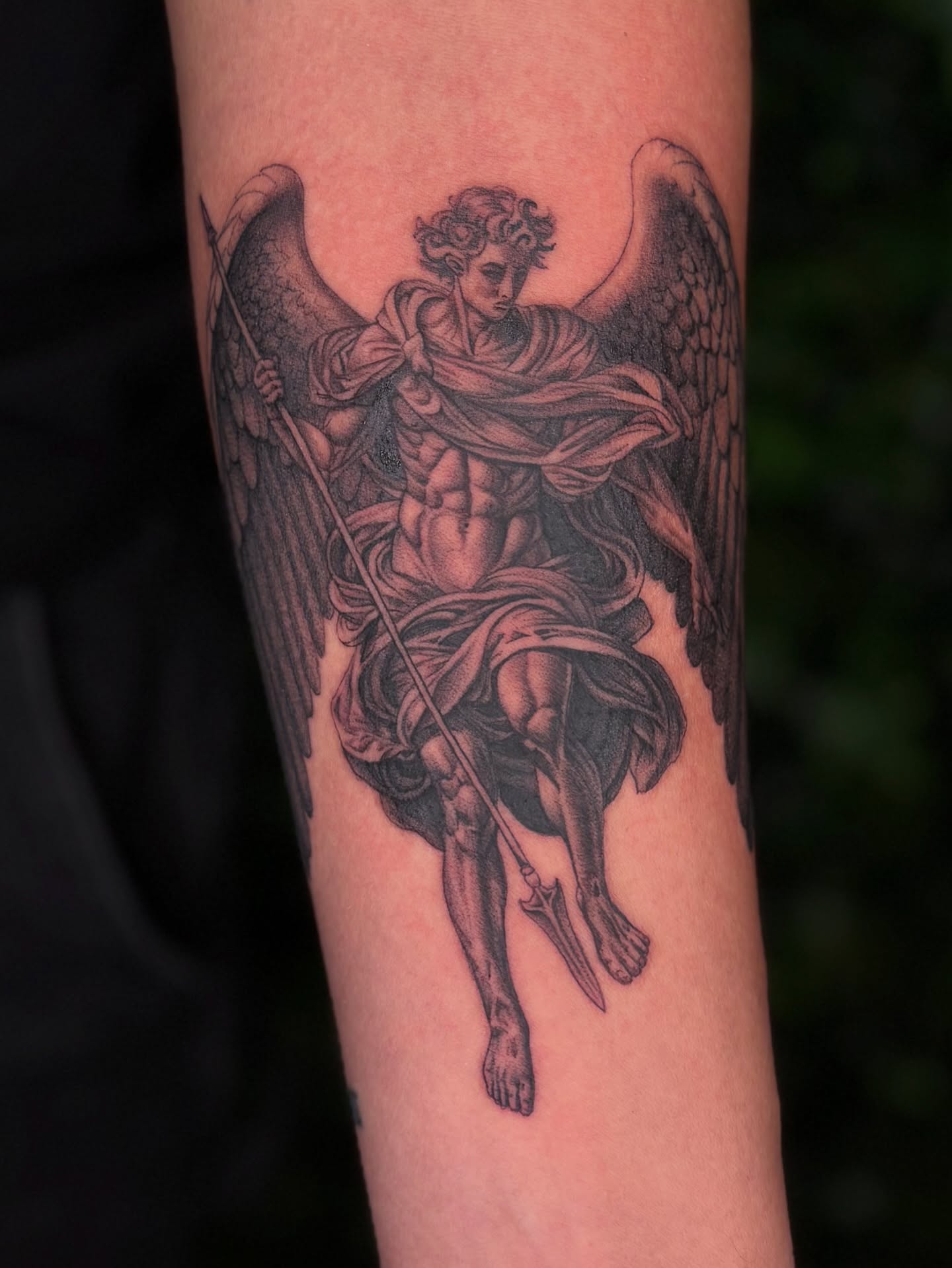 Angel with sword black and grey tattoo on the forearm by Jaiden Ducoff