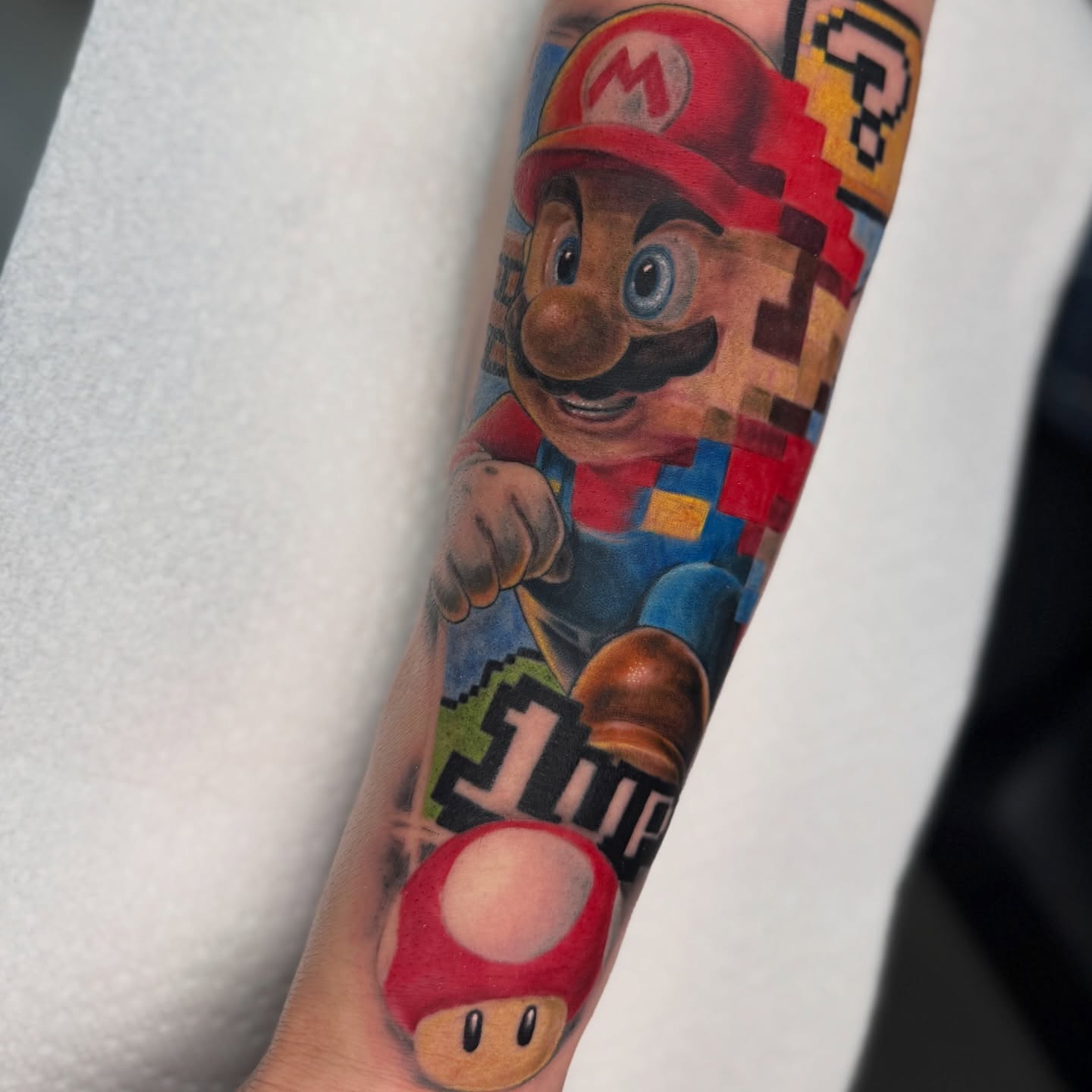 Super Mario realism tattoo on the forearm by Justin Hay