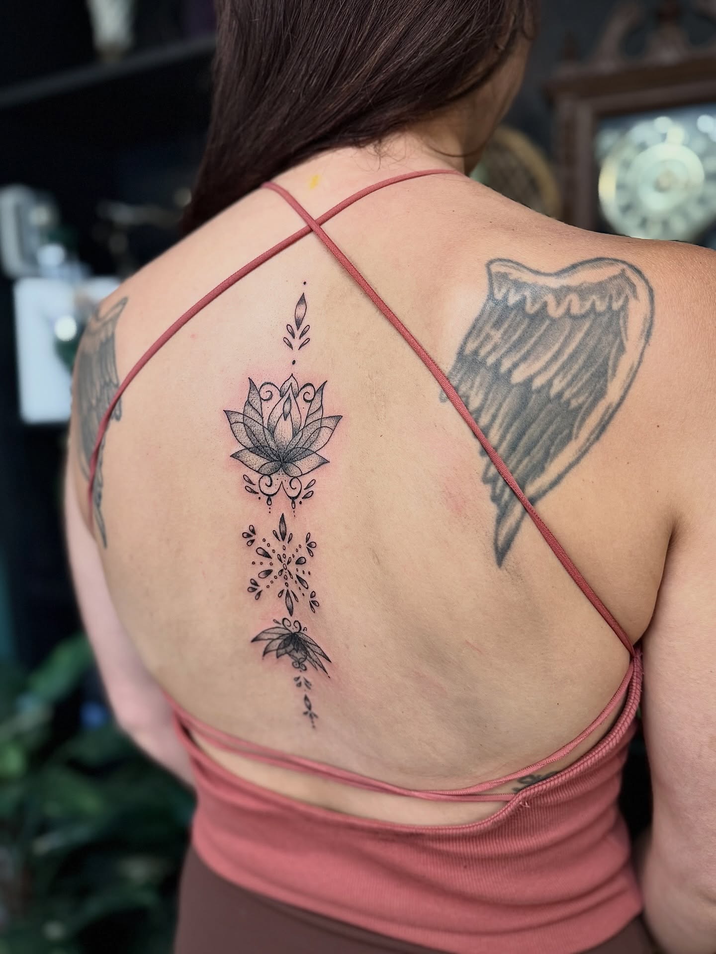 Lotus flower and wings black and grey tattoo on the back by Haley Bates