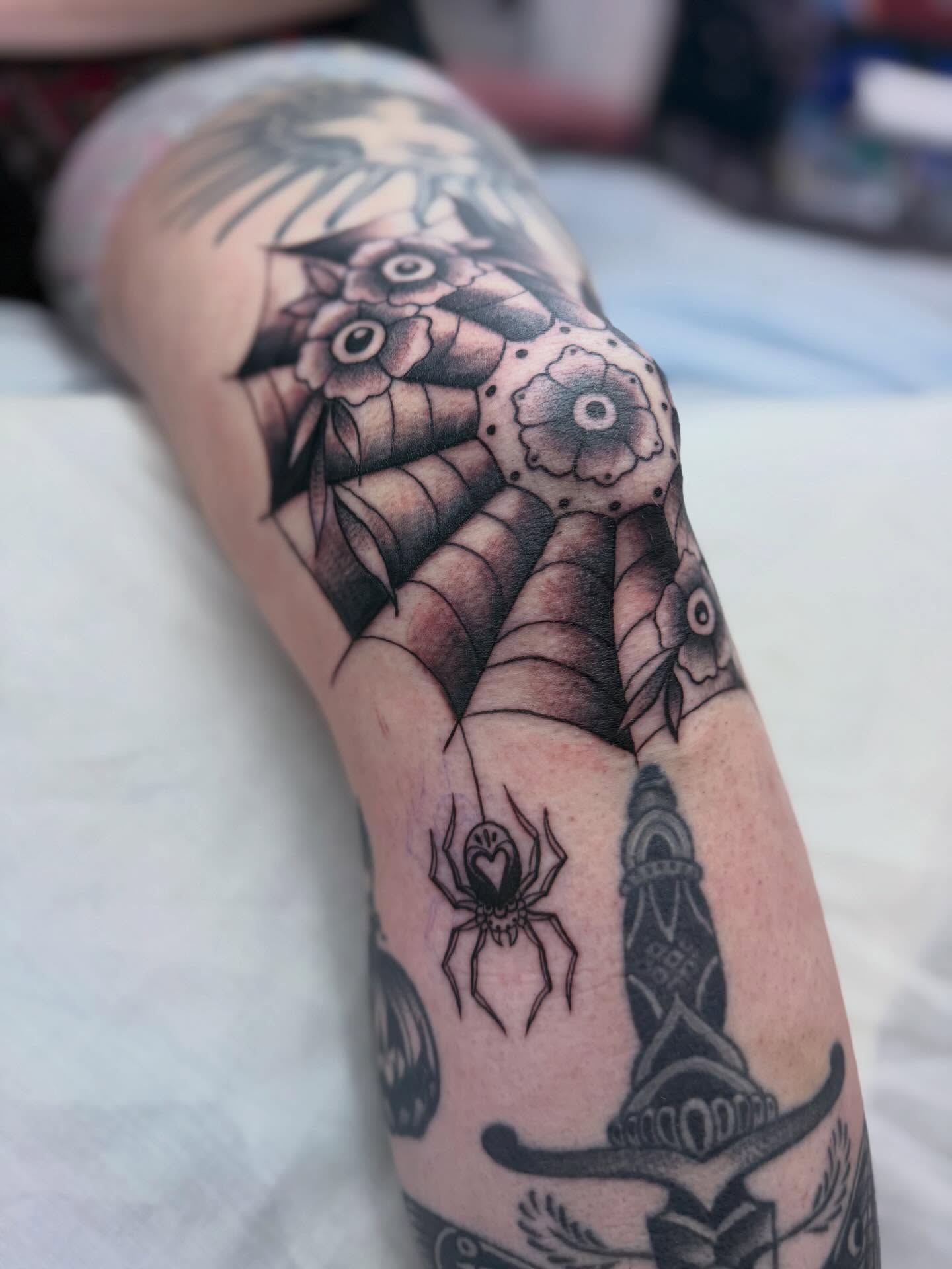 Spider and dagger geometric tattoo on the forearm by Sasha “Sashimi” Shabasov