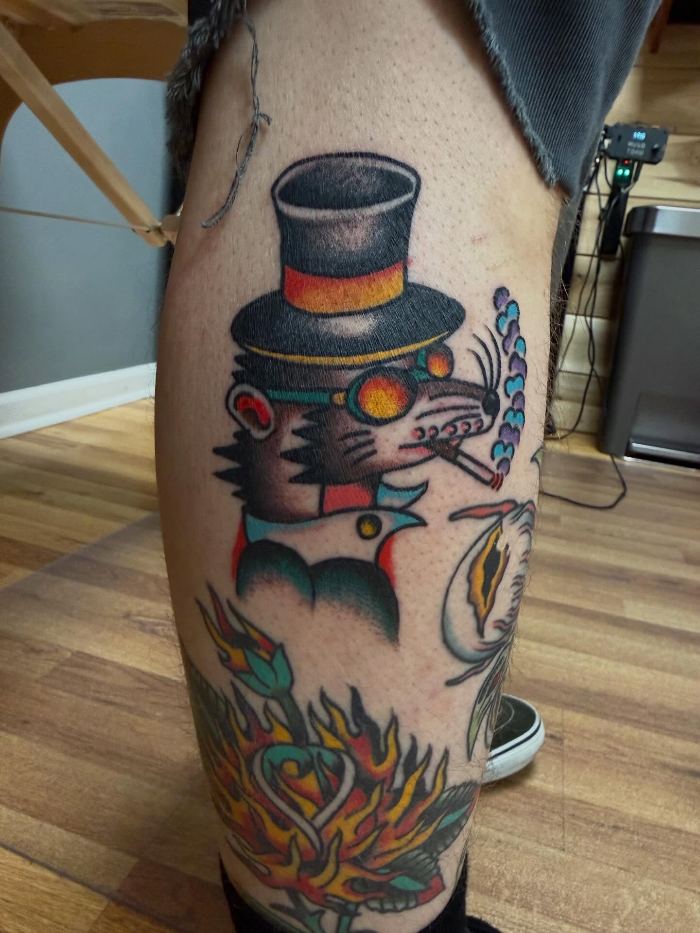 Top hat rat American traditional tattoo on the thigh by Chris Dufresne