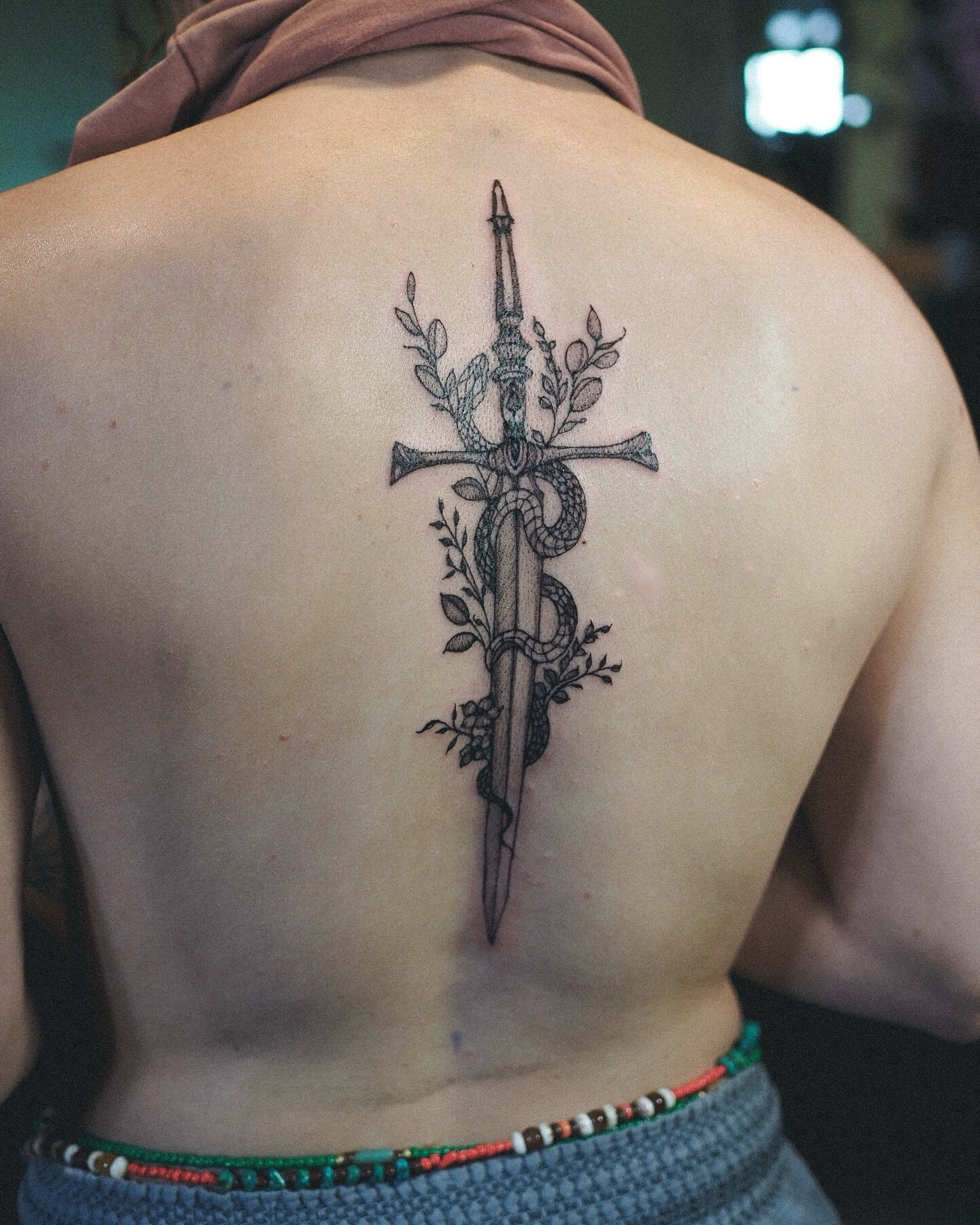 Sword and snake black and grey tattoo on the back by Inks by Nastia