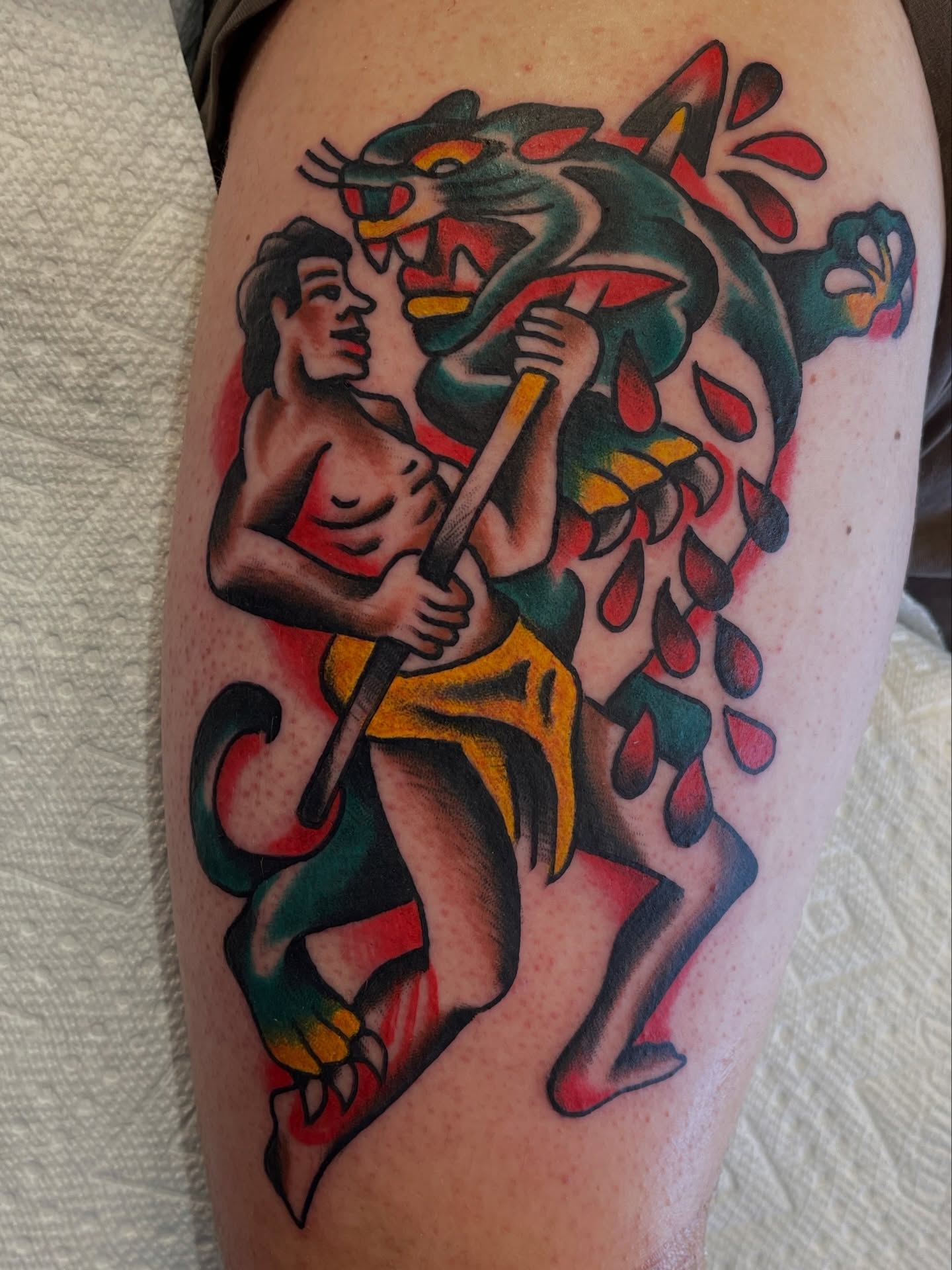 Man fighting panther American traditional tattoo on the thigh by Alex Garcia - Sac City Tattoo