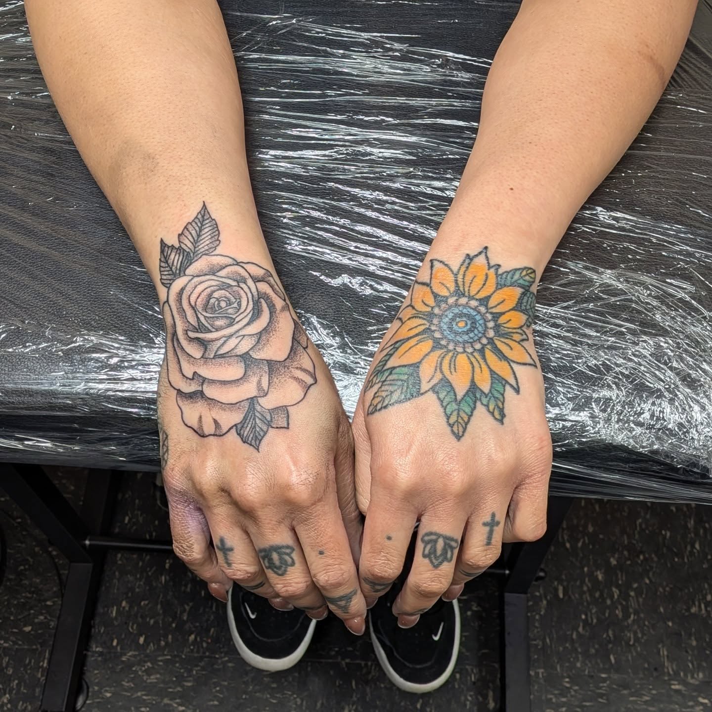 Rose and sunflower dotwork tattoo on the hand by Kam