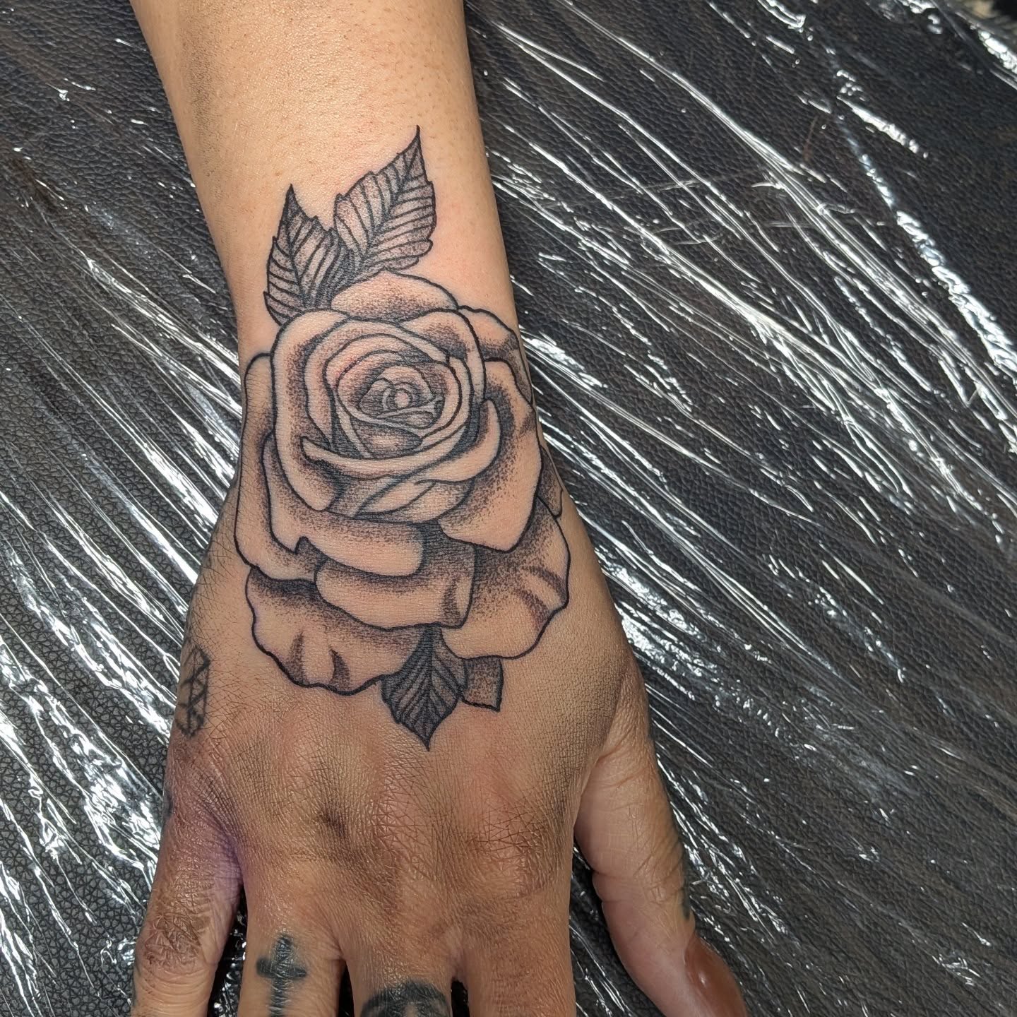 Rose dotwork tattoo on the hand by Kam