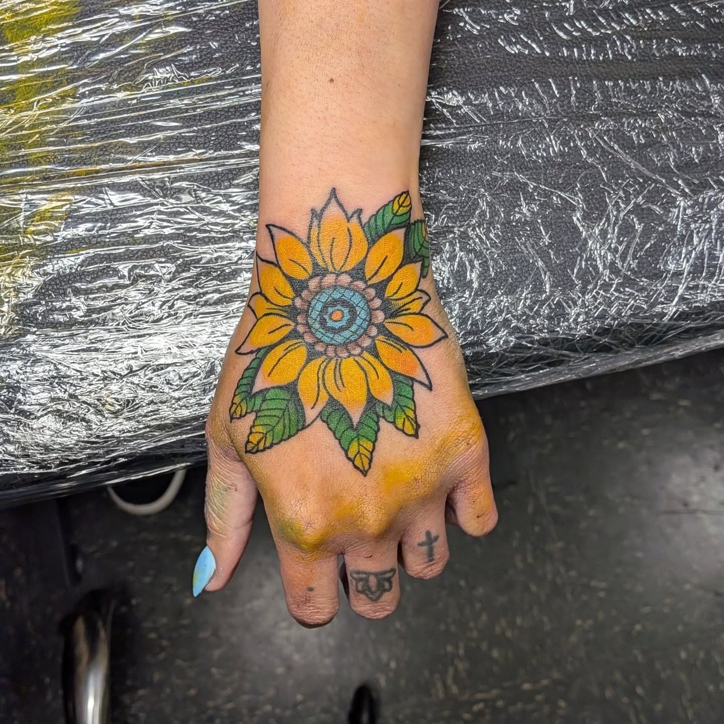 Sunflower new school tattoo on the hand by Kam