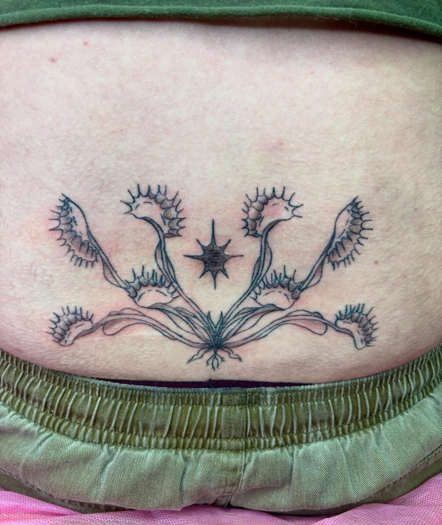 Venus flytrap black and grey tattoo on the torso by Hiro Robinson