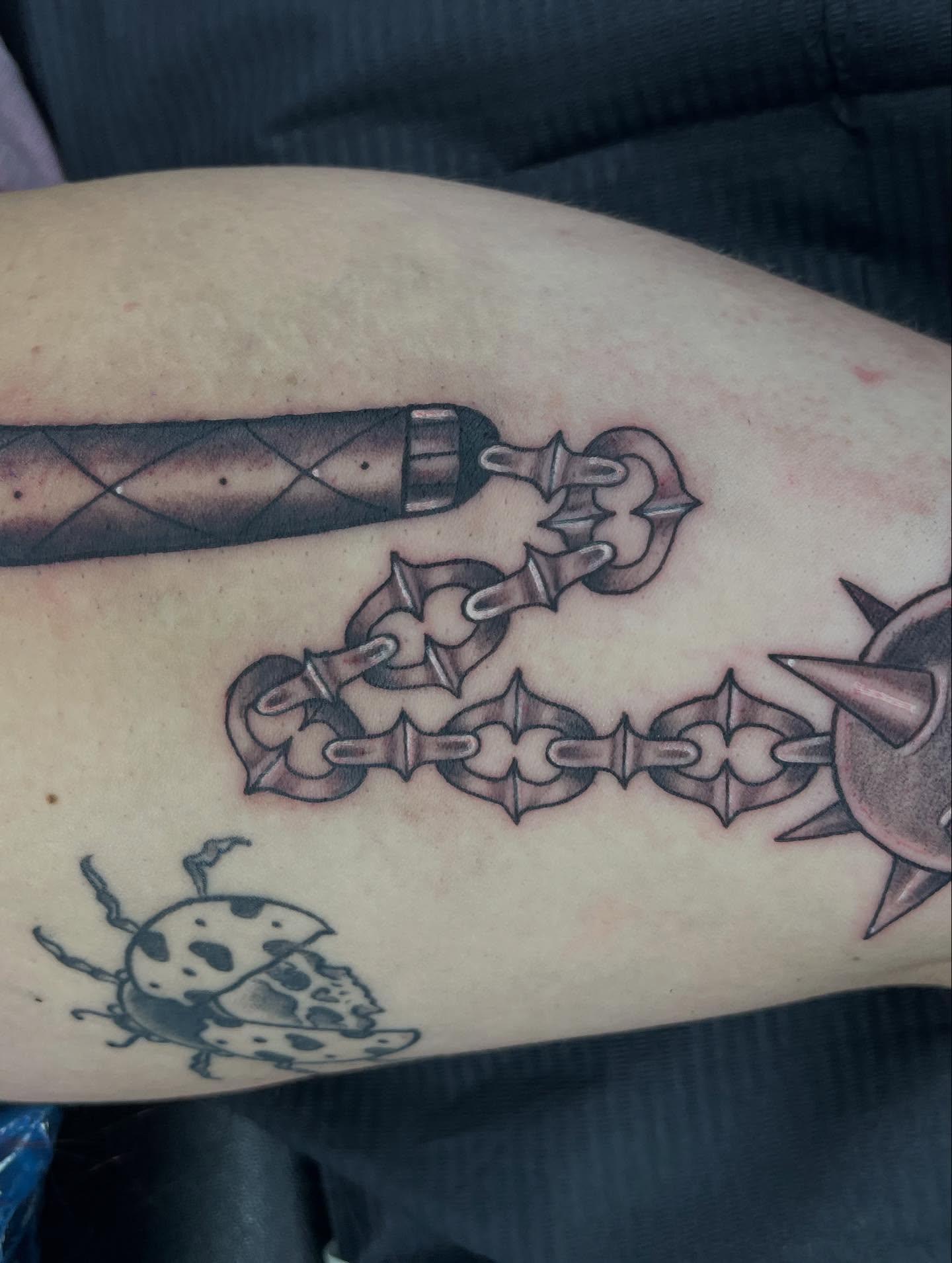 Chain and dagger black and grey tattoo on the forearm by @artinjections667