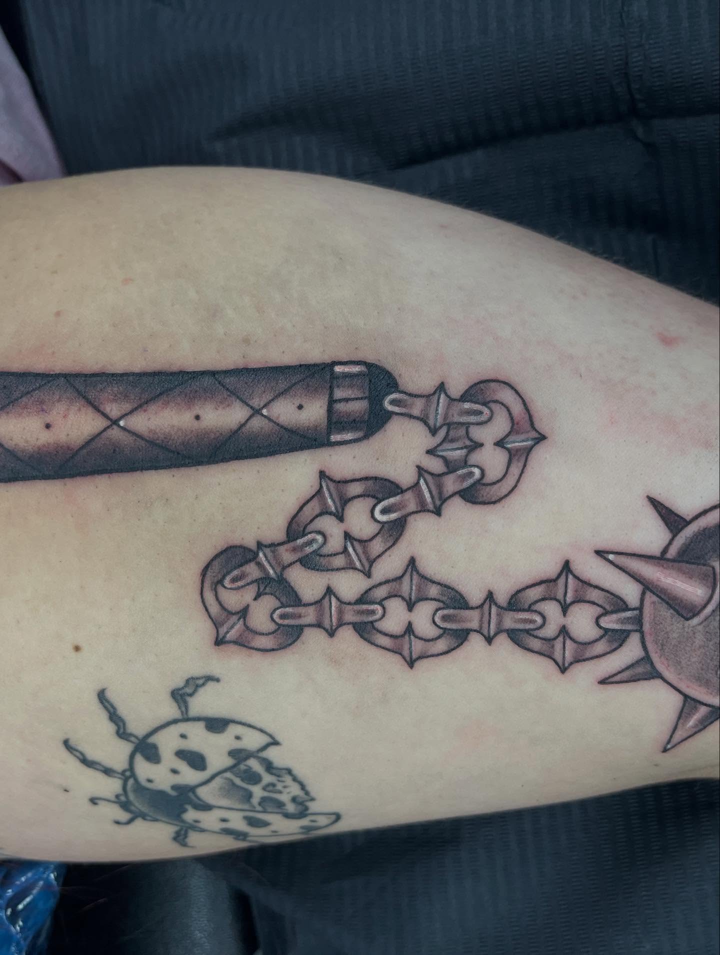 Chain and dagger black and grey tattoo on the forearm by @artinjections667