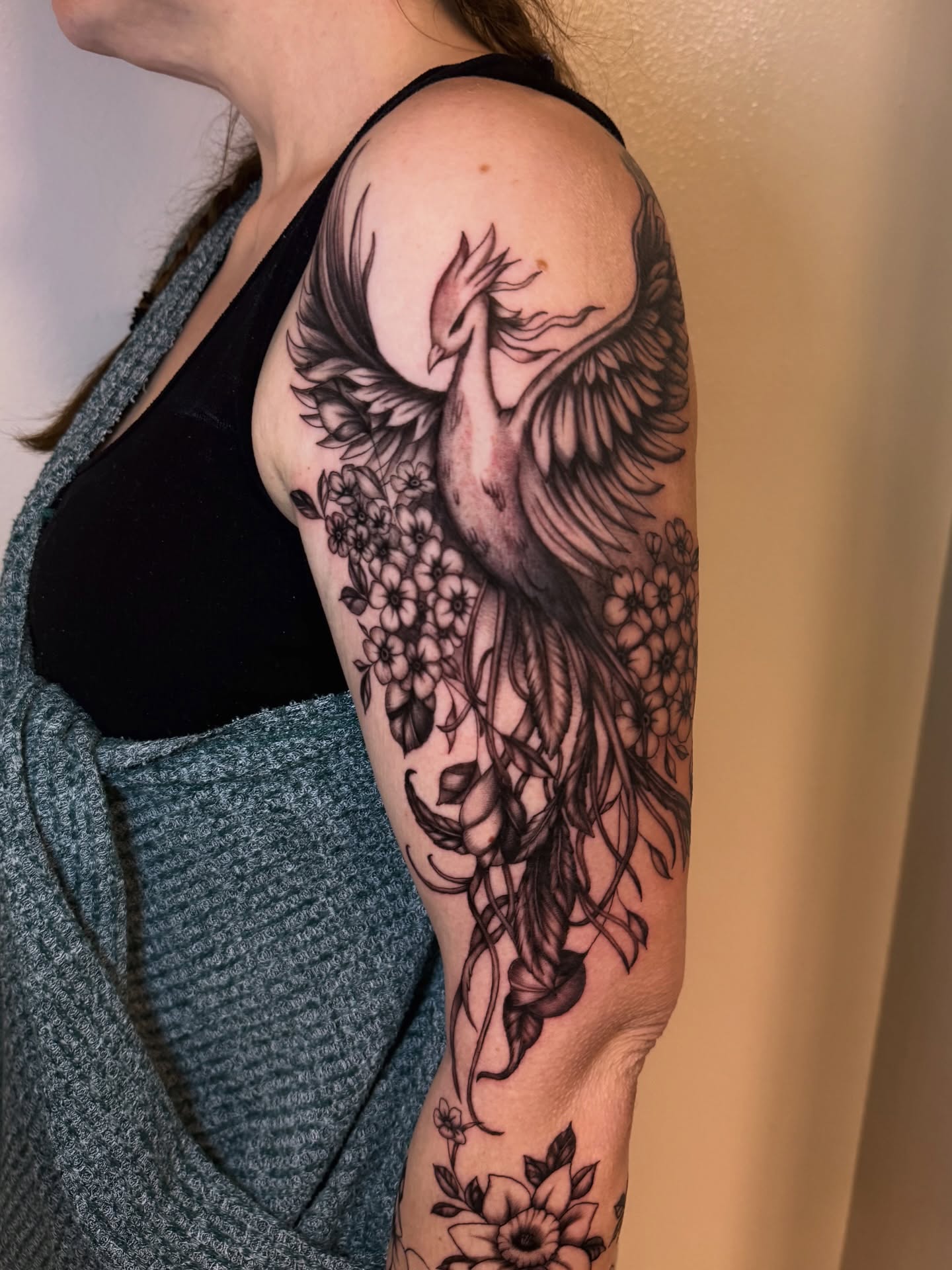 Phoenix black and grey tattoo on the upper arm by utah tattoo artist