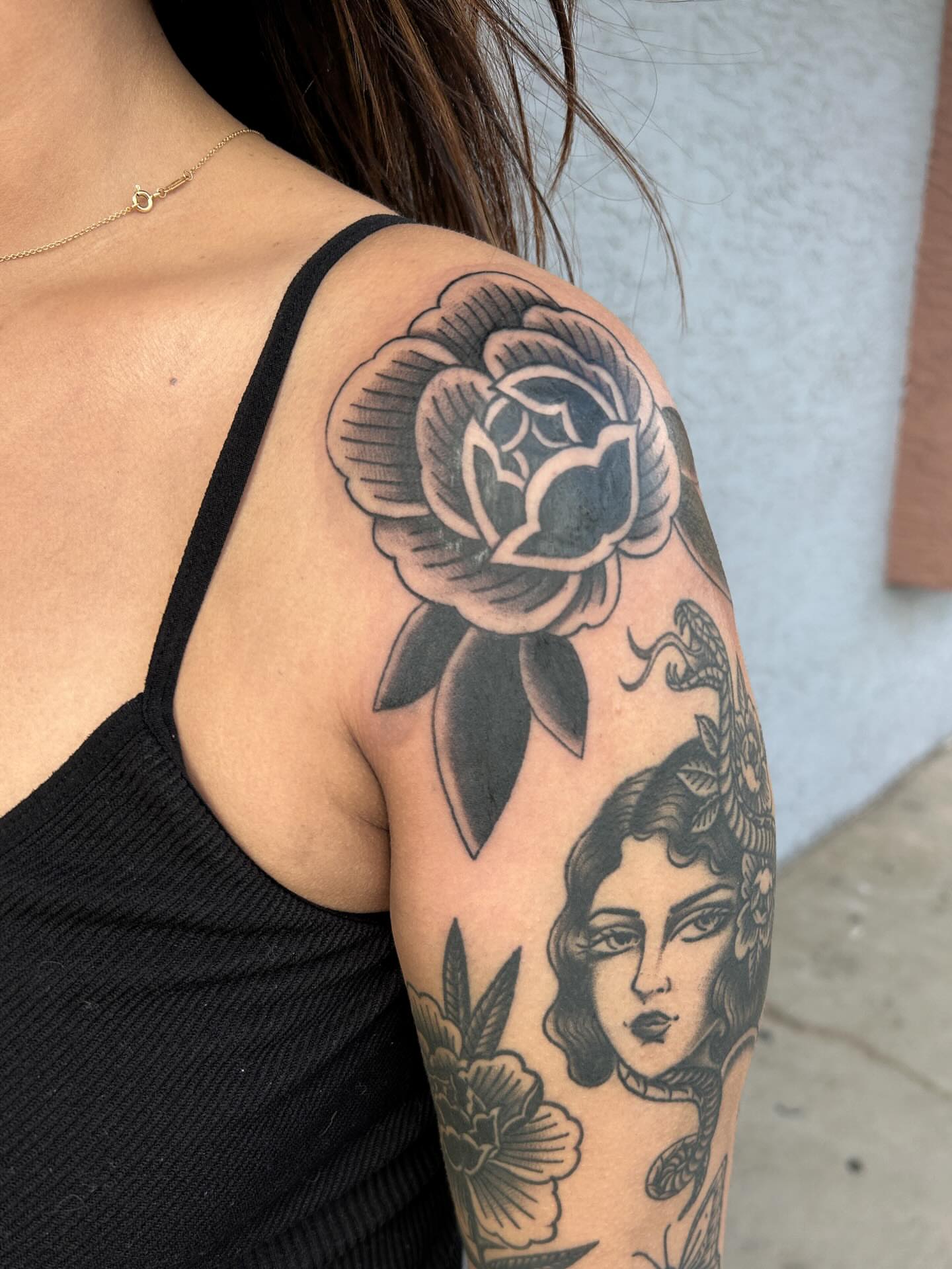 Rose and woman black and grey tattoo on the upper arm by Janelle McCarthy