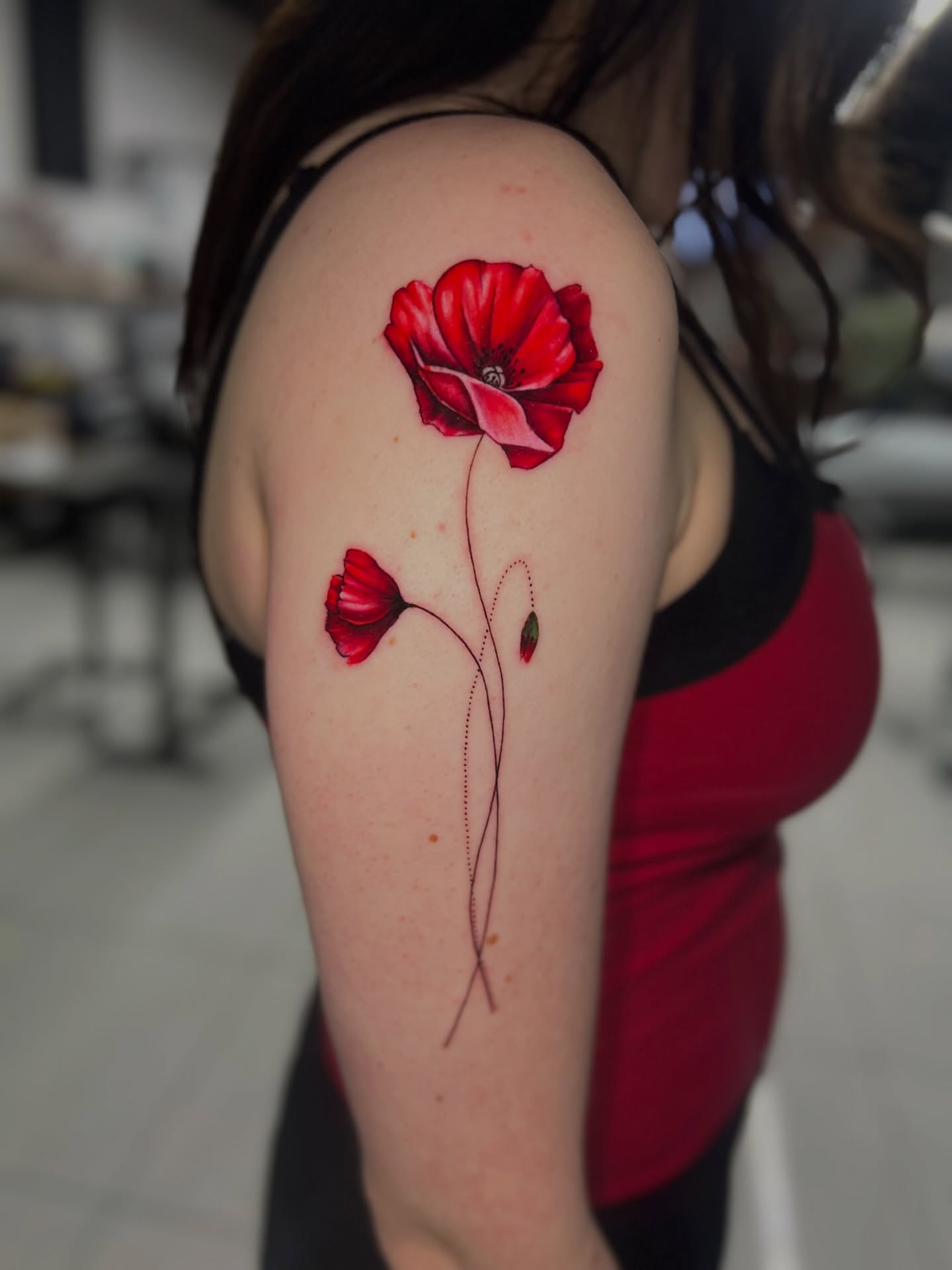 Red poppies realism tattoo on the upper arm by Bay Area Tattoo Artist