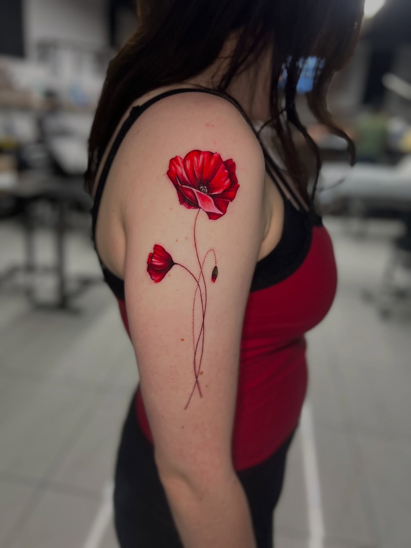 Red poppies realism tattoo on the upper arm by Bay Area Tattoo Artist