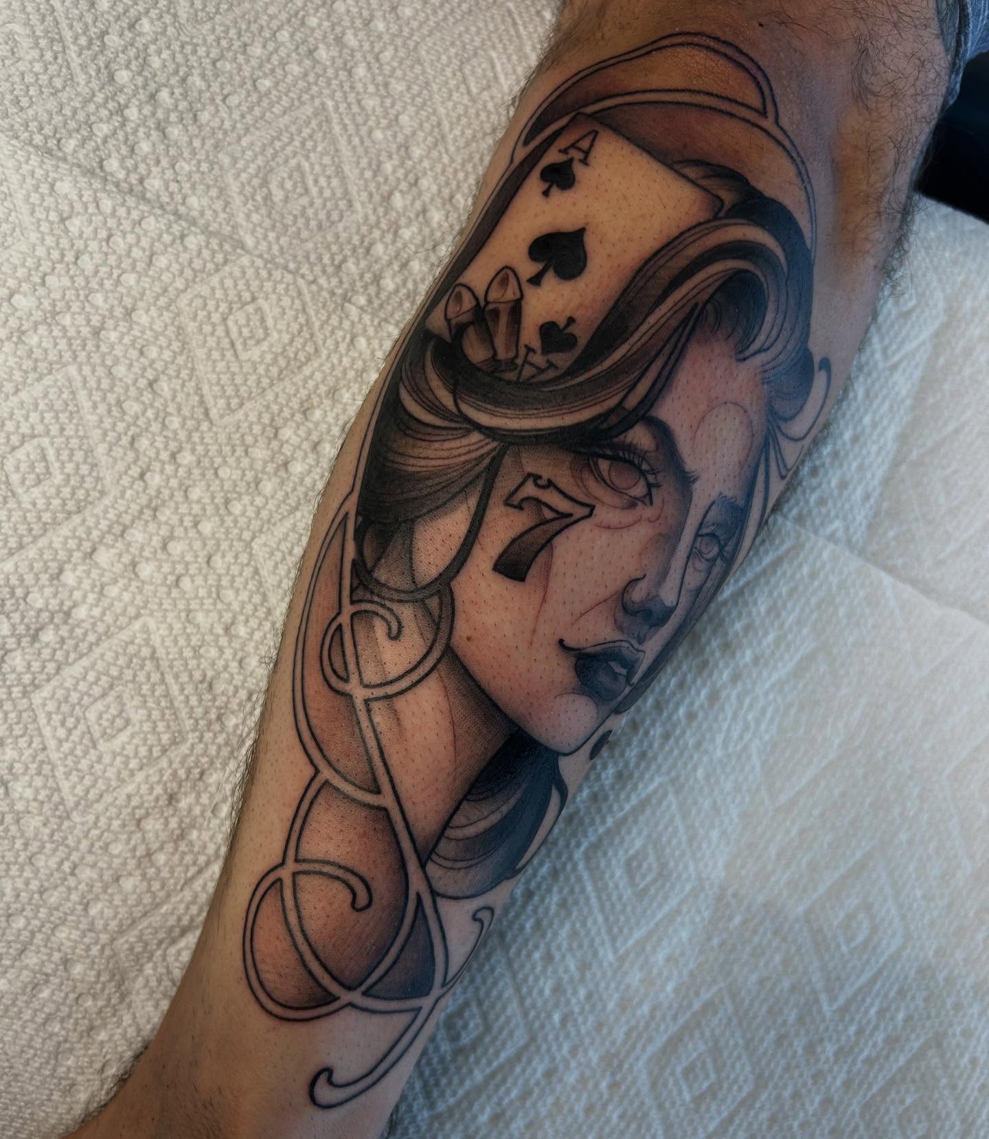 Woman with playing card realism tattoo on the forearm by Kayla Fay, Baton Rouge, Louisiana
