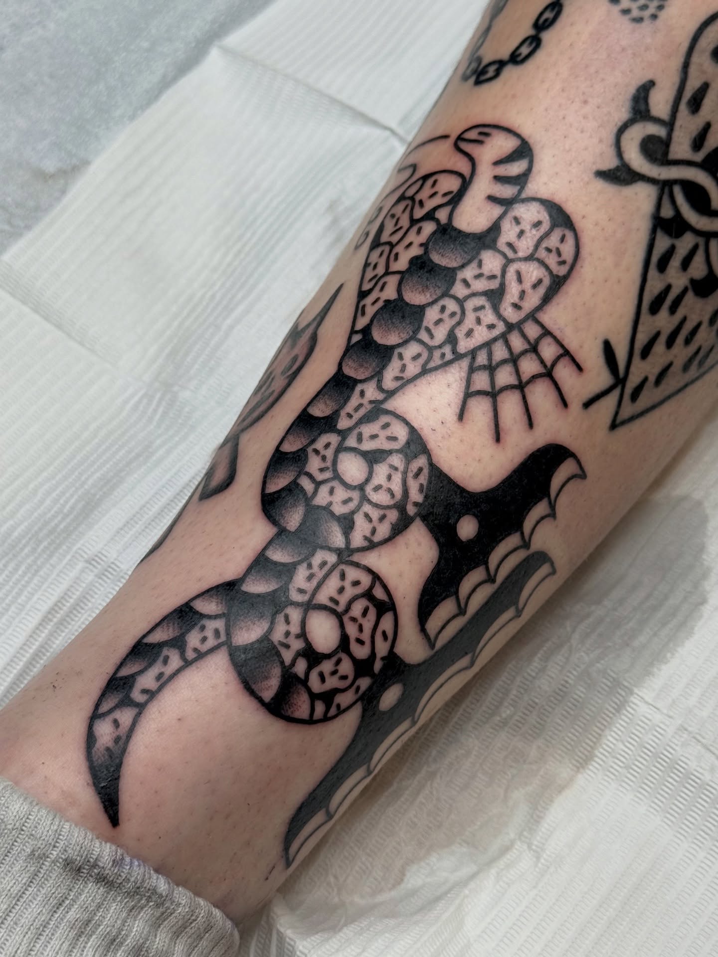 Snake American traditional tattoo on the forearm by Roman