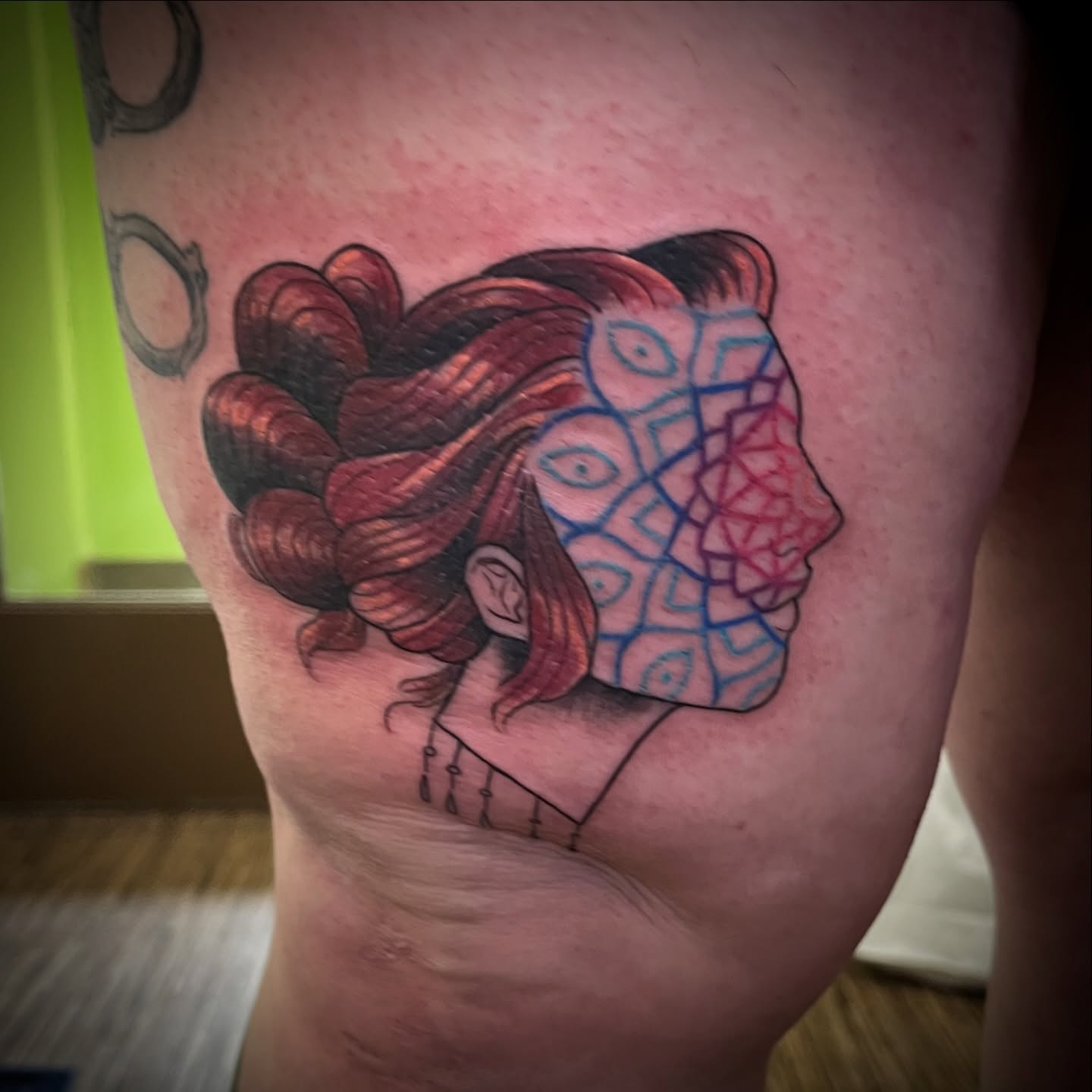 Woman with patterned face geometric tattoo on the thigh by Lacey B, Portland, Oregon