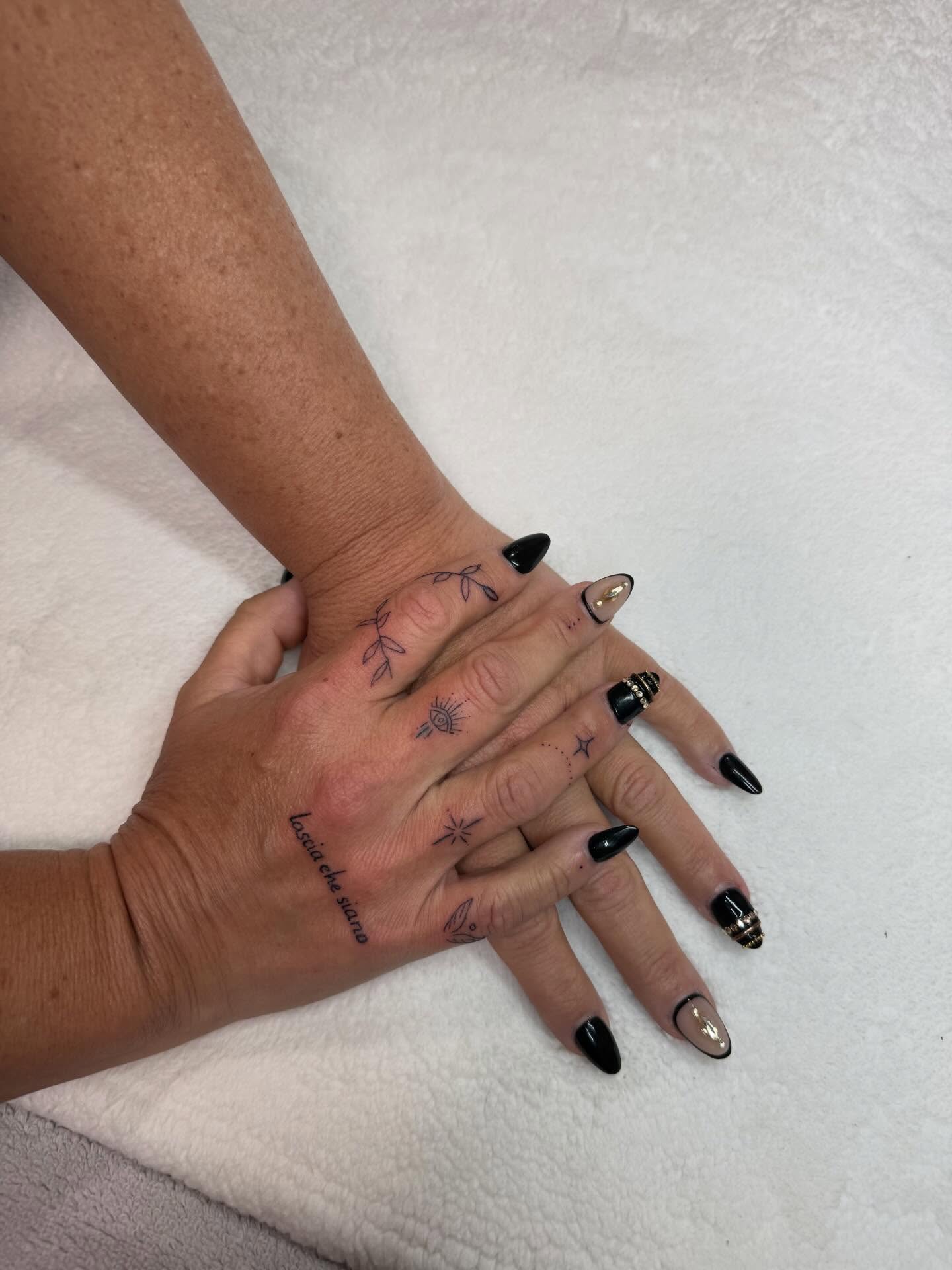 Eye and floral motifs fine line tattoo on the hand by Lexie Decker, Canton, Ohio
