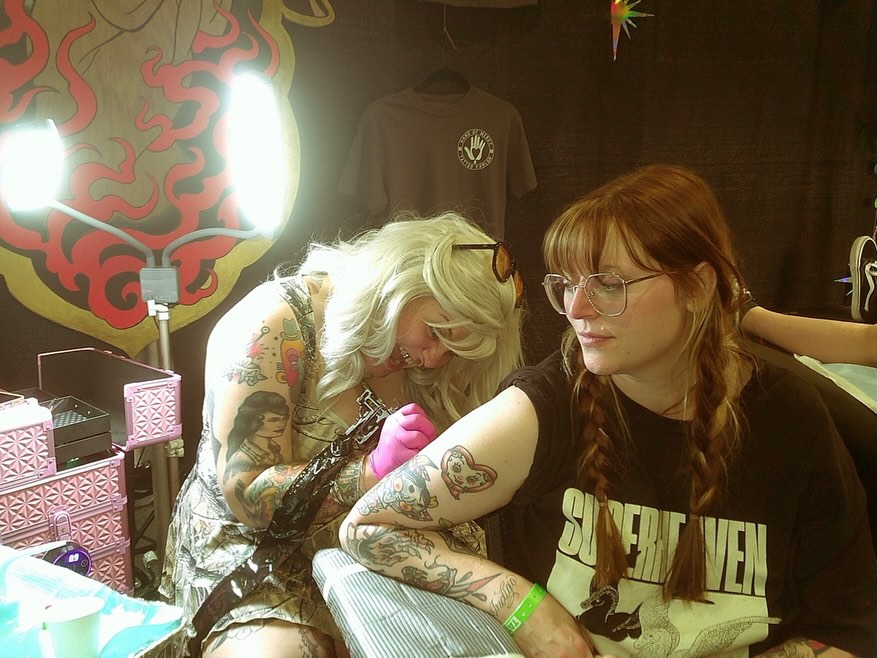 Woman with long red hair American traditional tattoo on the upper arm by madelynne (maddie) caldwell tattoos