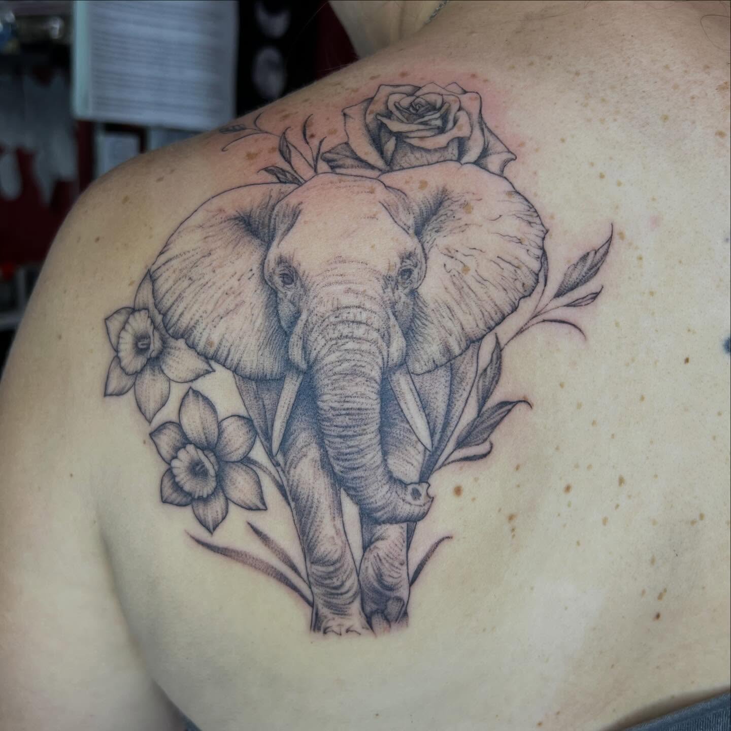 Elephant and flowers dotwork tattoo on the shoulder by Dark Luna Tattoos LLC