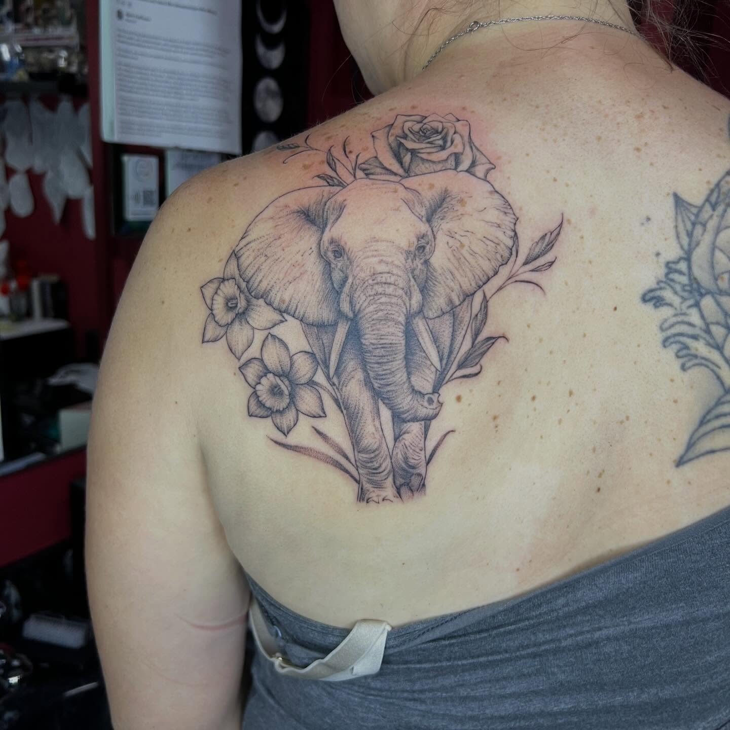 Elephant and flowers realism tattoo on the back by Dark Luna Tattoos LLC