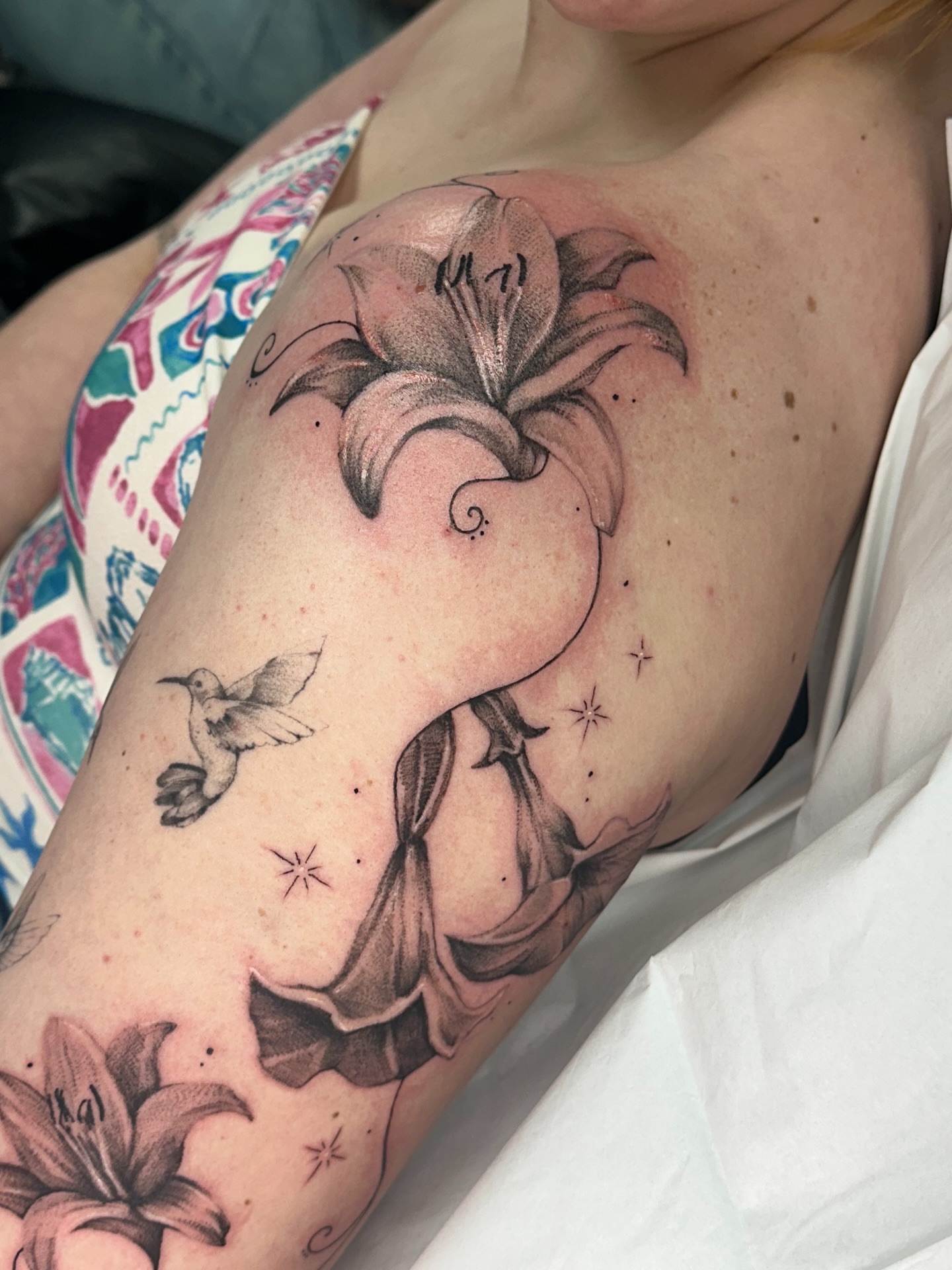 Lily black and grey tattoo on the shoulder by Halle Cooper