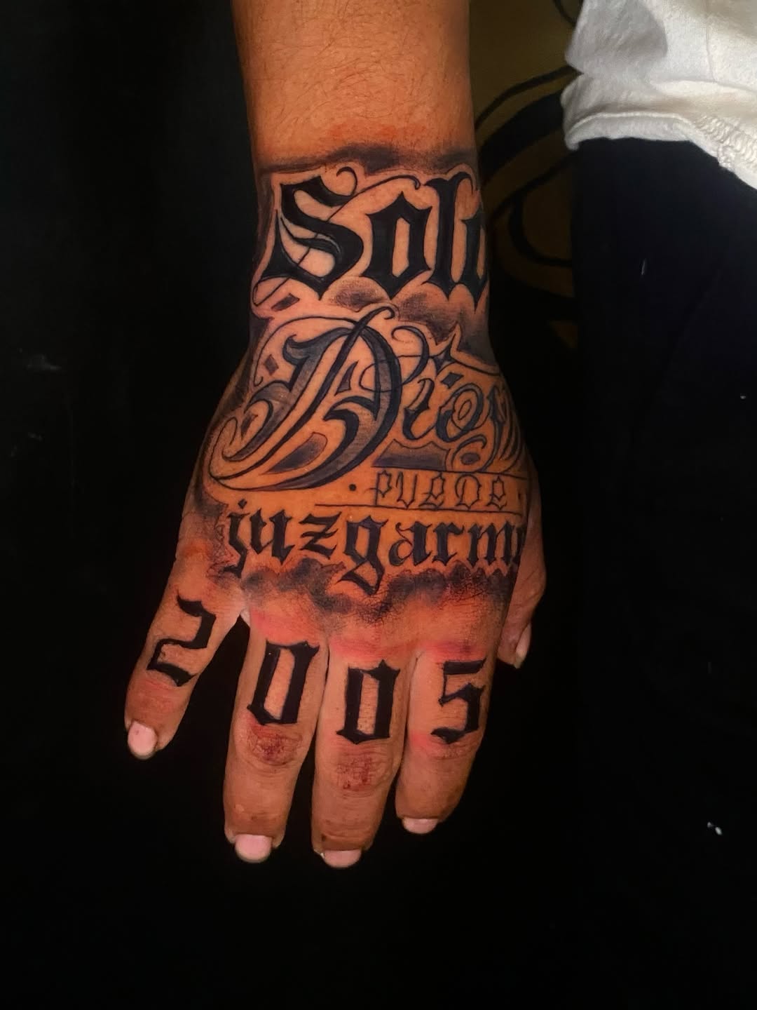 Script lettering and numbers lettering tattoo on the hand by Irving Guzman