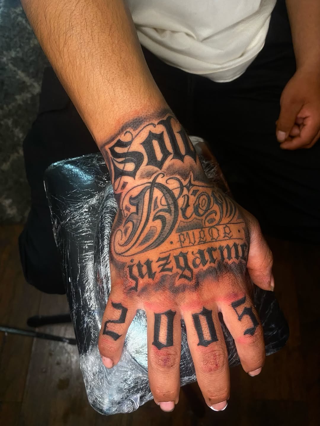 Script lettering and numbers lettering tattoo on the hand by Irving Guzman
