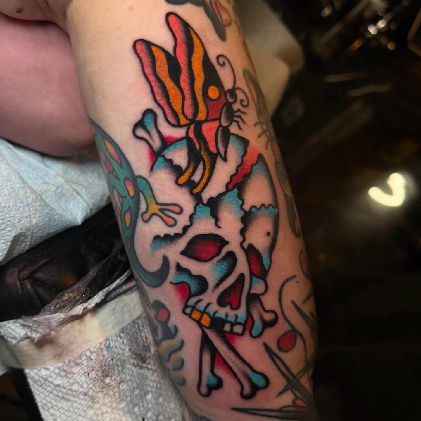 Skull and bird American traditional tattoo on the forearm by Julia Louise