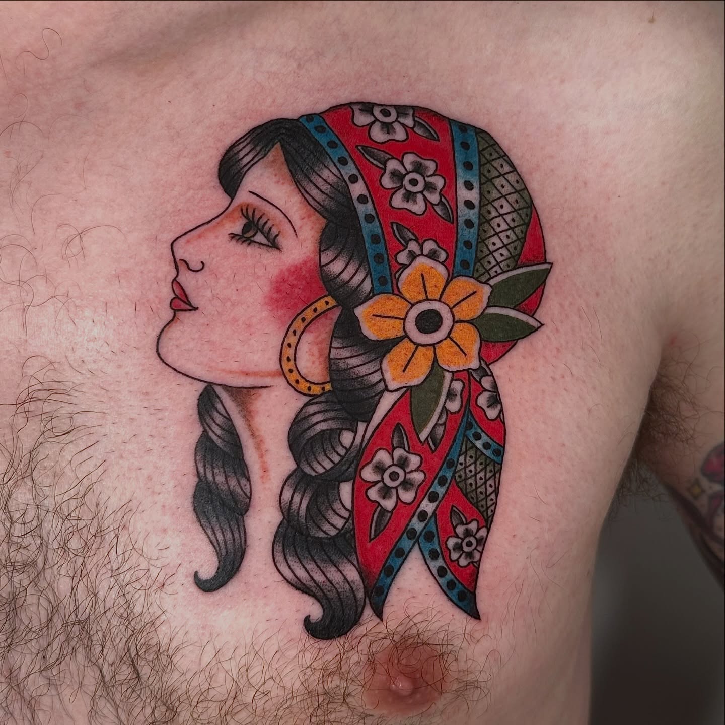 Woman with bandana American traditional tattoo on the chest by sechi