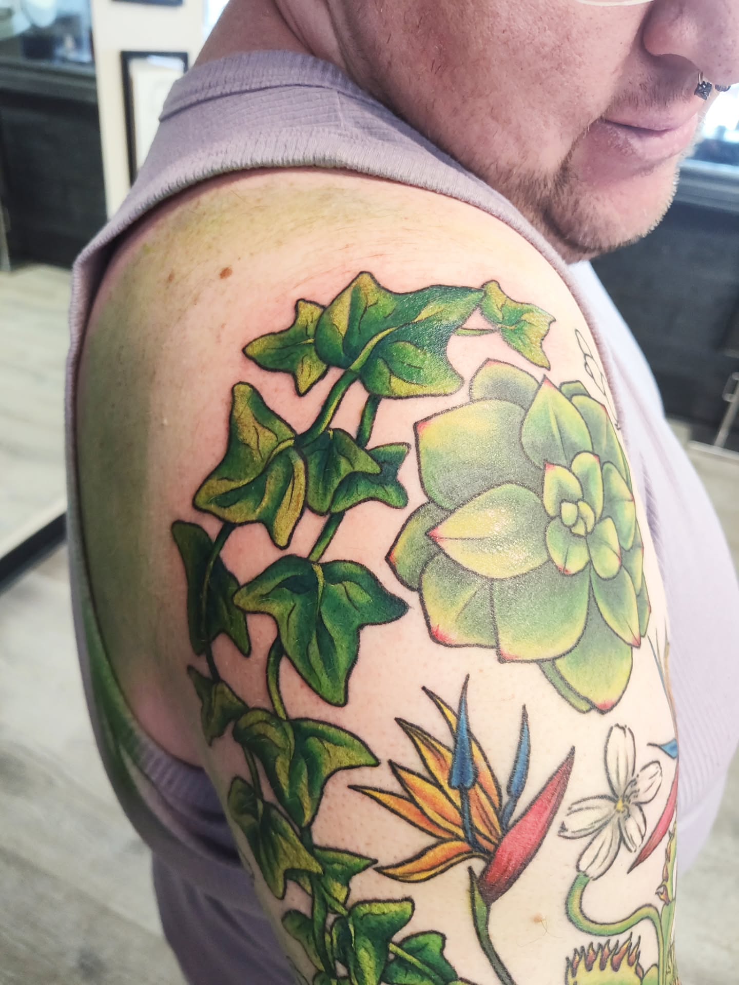 Succulent and bird of paradise realism tattoo on the shoulder by Mercury