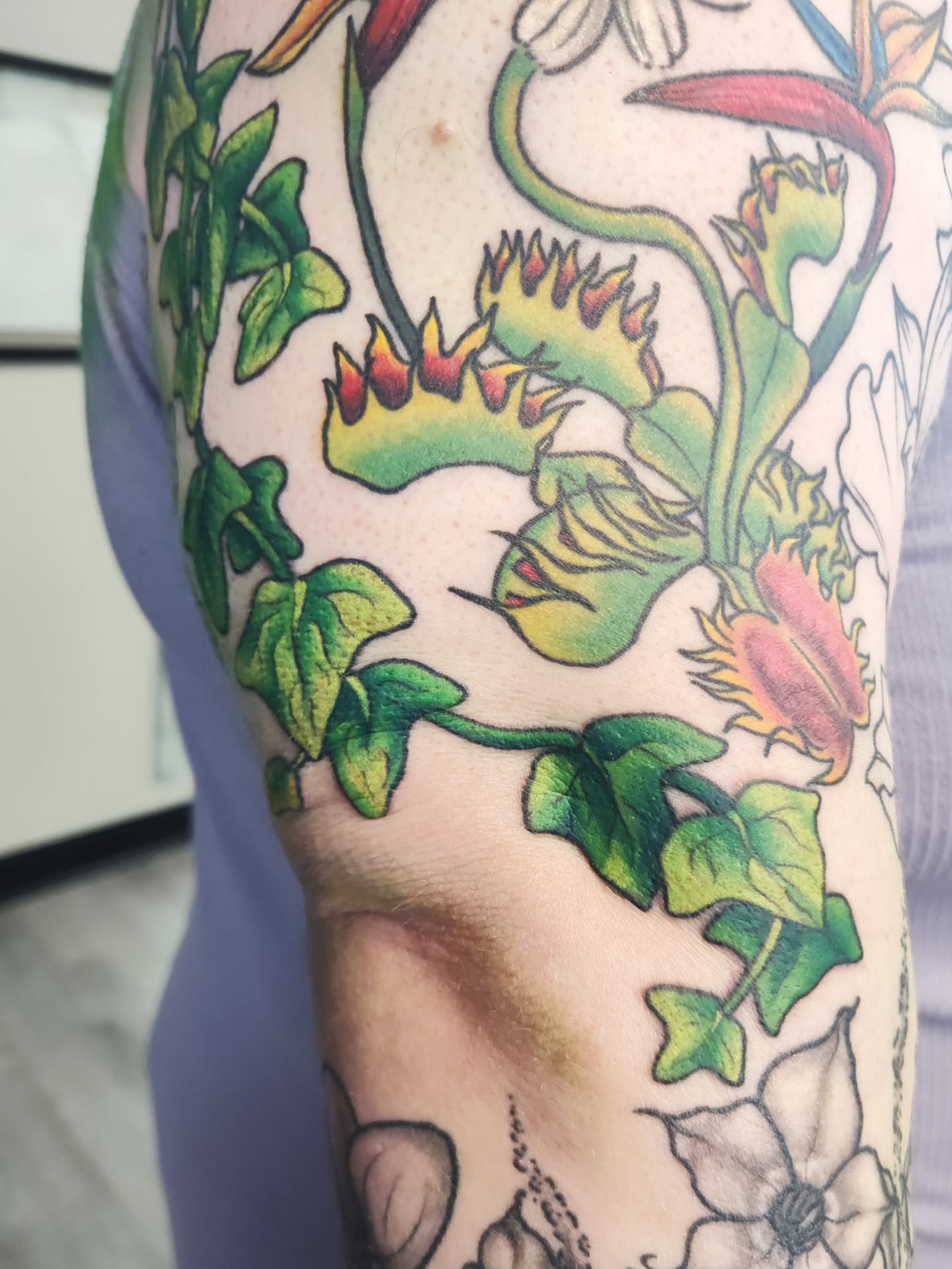 Ivy and flowers new school tattoo on the forearm by Mercury