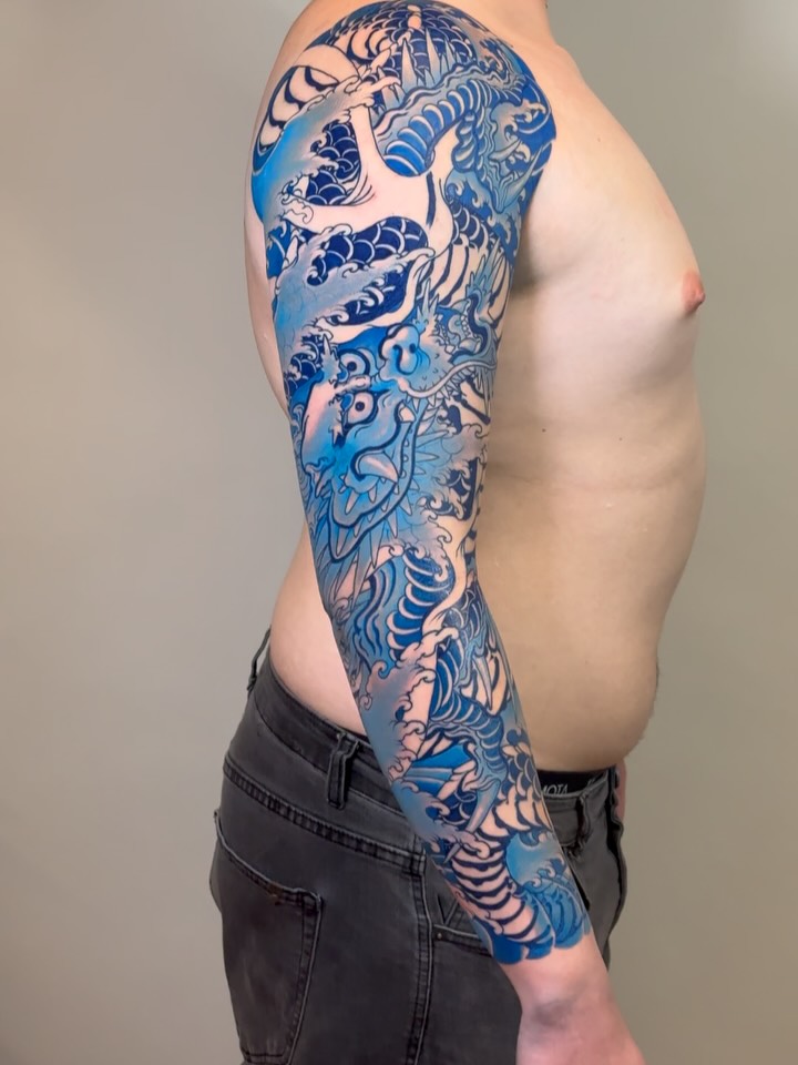 Dragon and waves japanese irezumi tattoo on the upper arm by Alezumie