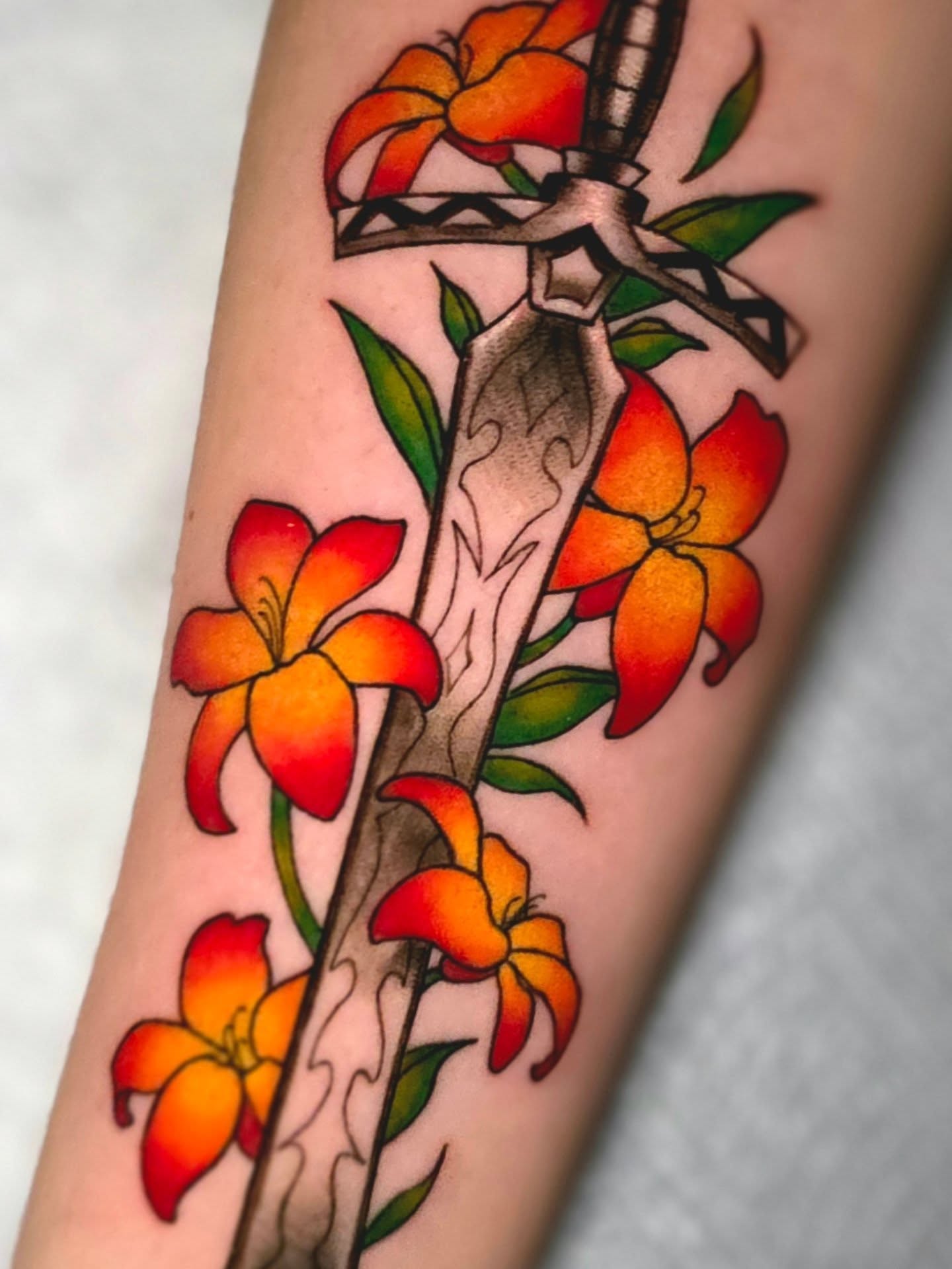 Sword and flowers American traditional tattoo on the forearm by April High ☆ Tattoo Artist