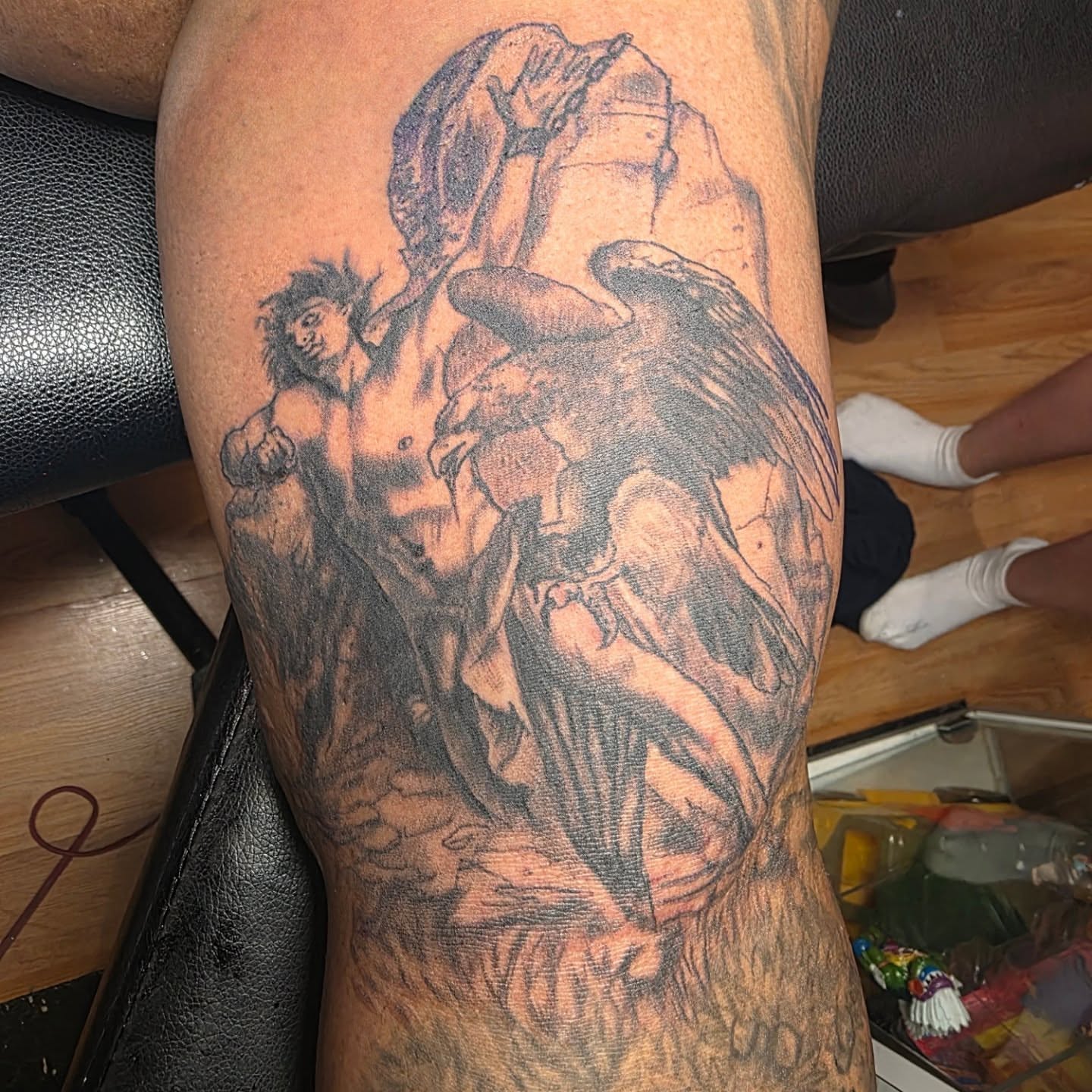 Angel and man realism tattoo on the thigh by Rusty Williams
