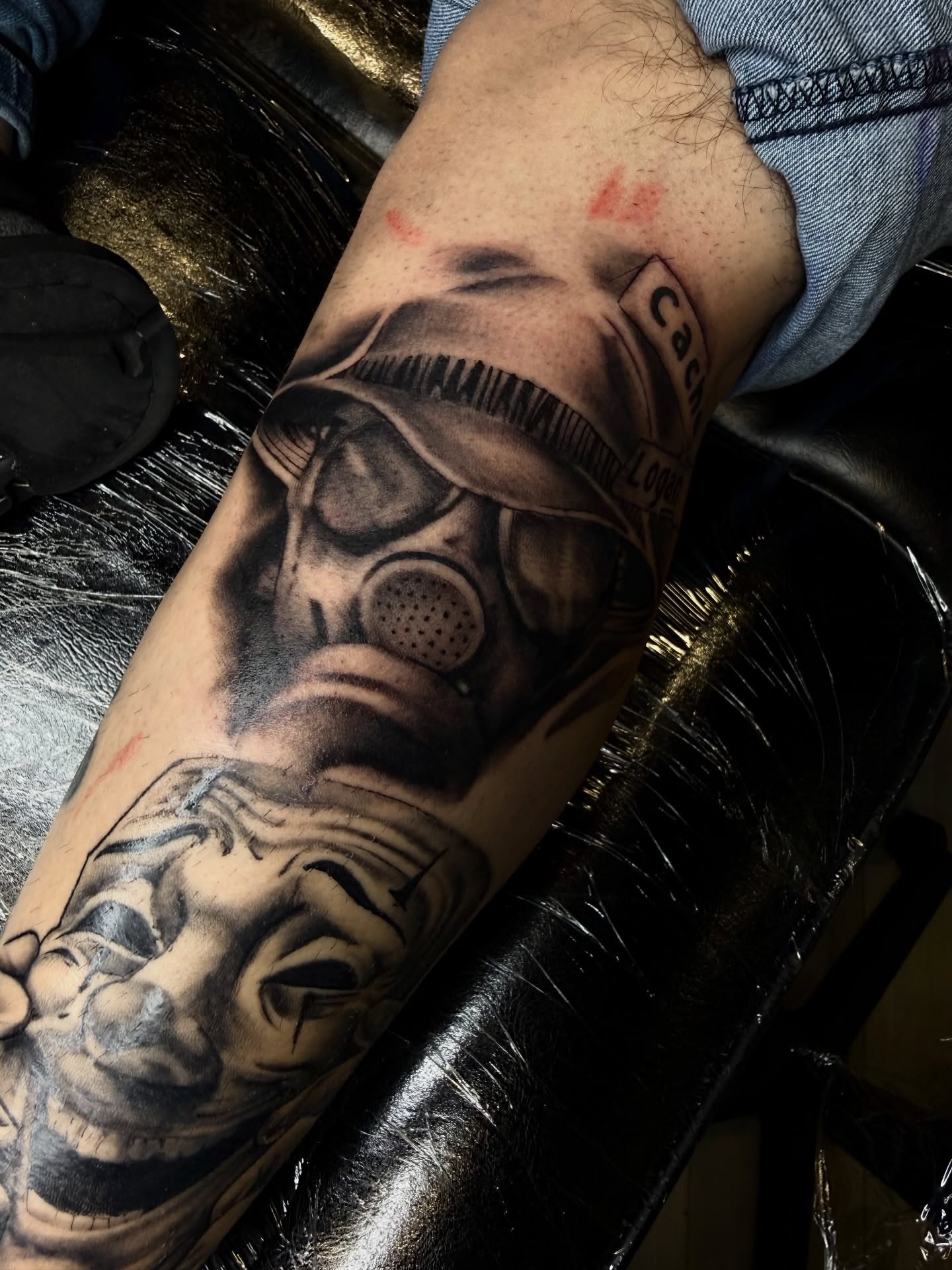Gas mask and clown realism tattoo on the forearm by Jennifer Contreras