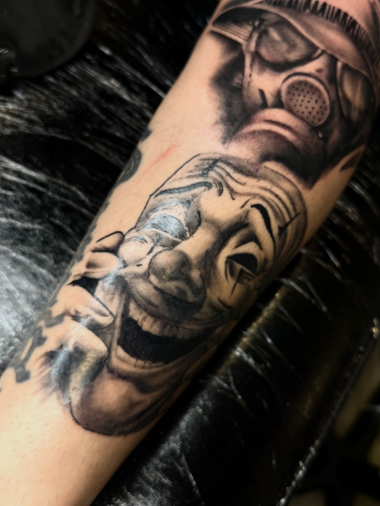 Smiling man wearing gas mask realism tattoo on the forearm by Jennifer Contreras