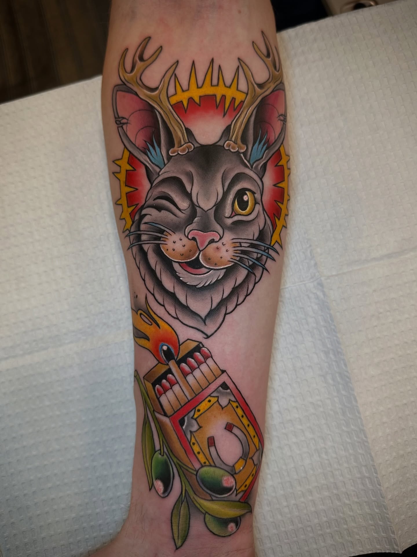 Cat with antlers American traditional tattoo on the forearm by Sam AlpineInk