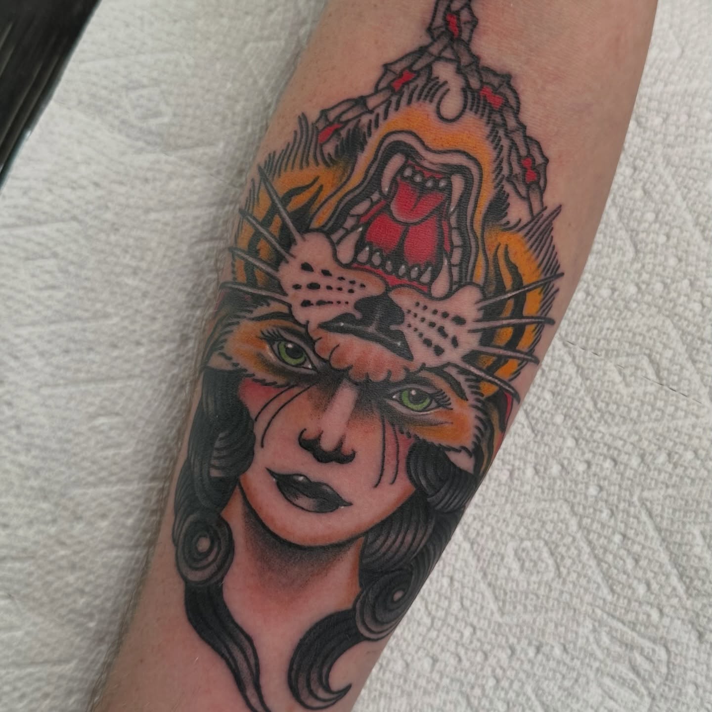 Woman with cat American traditional tattoo on the forearm by Christopher Layman