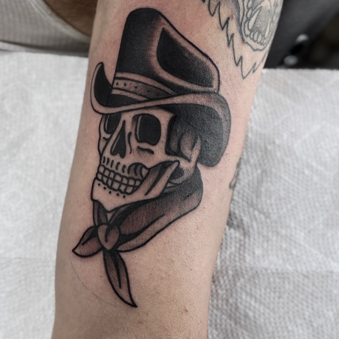 Cowboy skull American traditional tattoo on the forearm by Christopher Layman